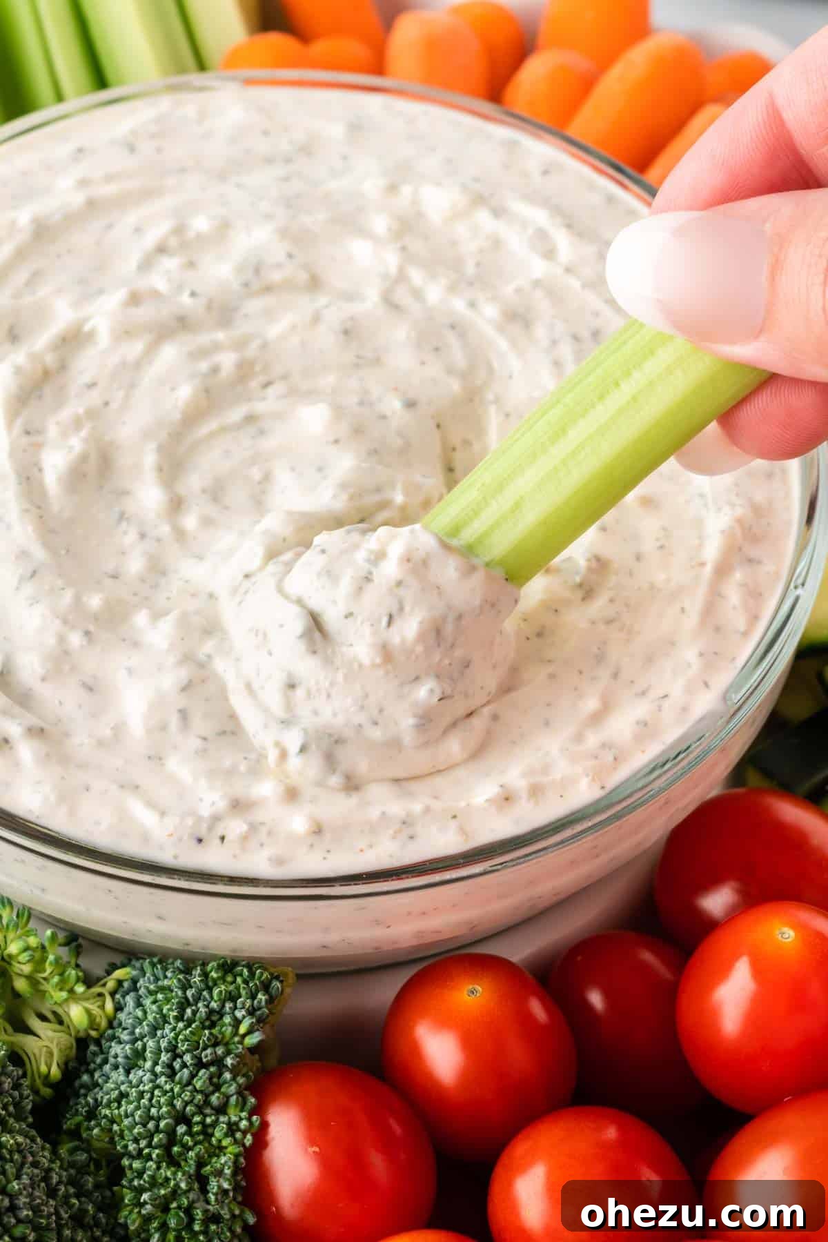 Garden Fresh Dip 3 A crisp celery stalk being dipped into a creamy, flavorful veggie dip, showcasing its perfect consistency and tempting appeal.