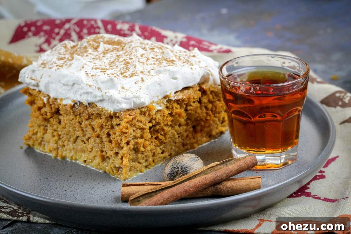 Amaretto-Infused Pumpkin Spice Tres Leches 4 Finished Pumpkin Spice Amaretto Tres Leches Cake, garnished with a dusting of cinnamon