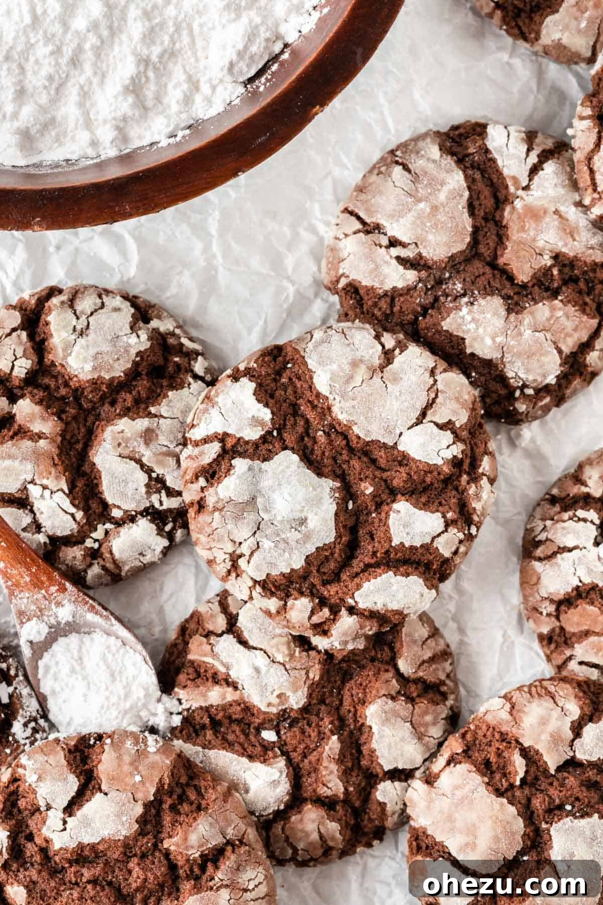 Fudgy chocolate cake mix crinkle cookies, stacked and dusted with powdered sugar
