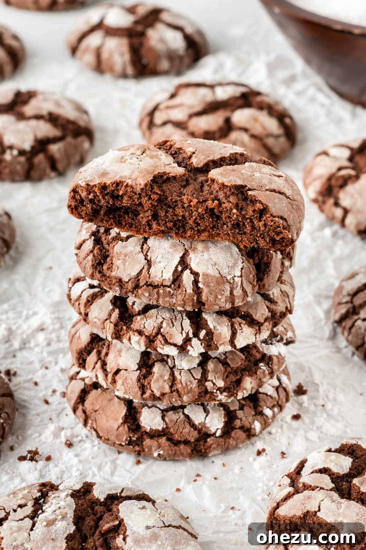 Stack of freshly baked cake mix crinkle cookies with powdered sugar