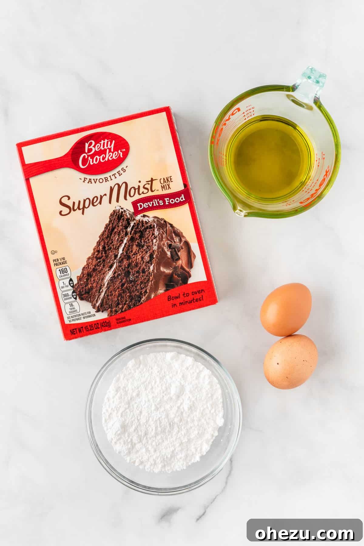 Ingredients laid out: chocolate cake mix, olive oil, eggs, and powdered sugar