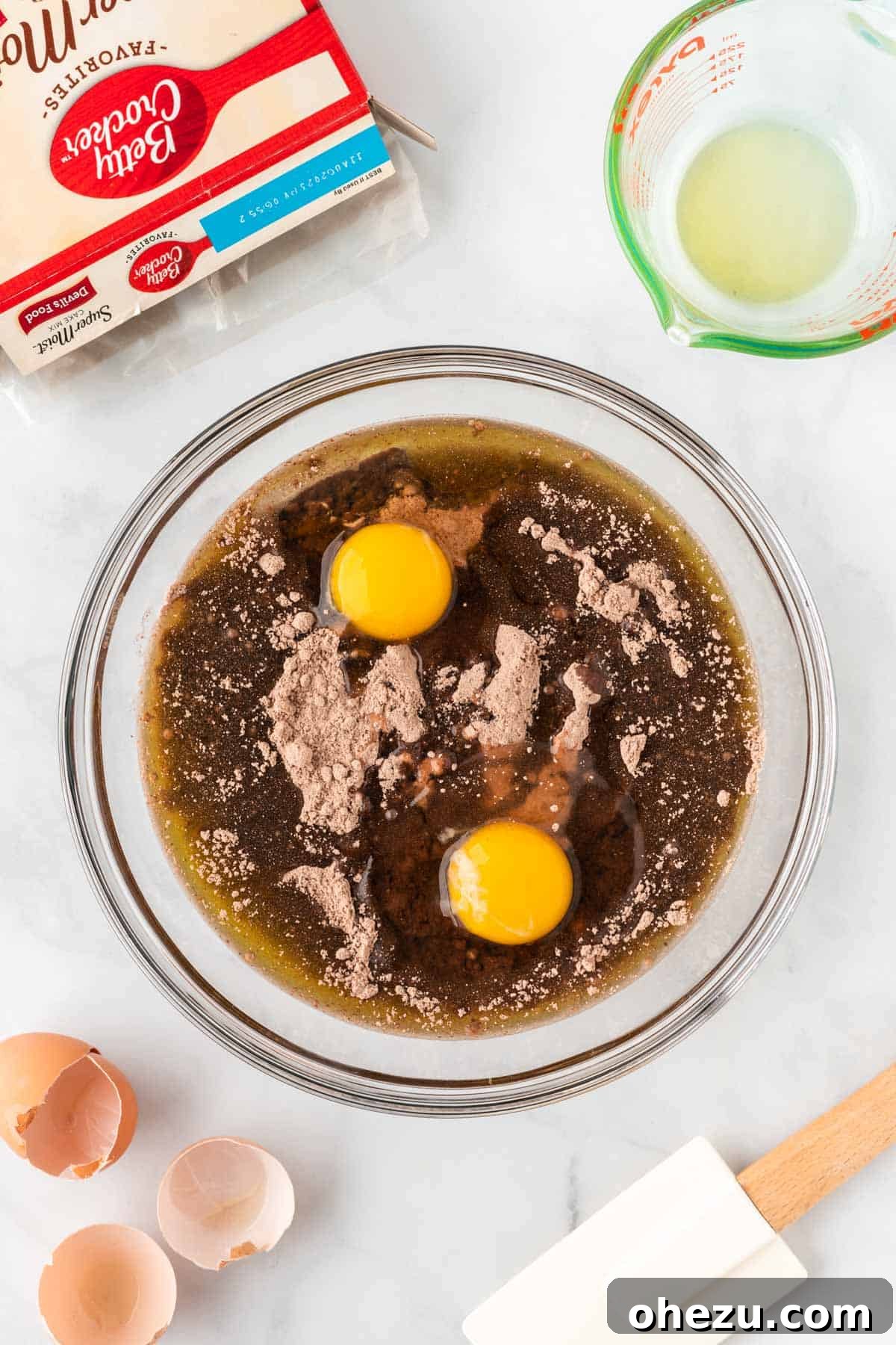 Adding eggs and oil to the chocolate cake mix