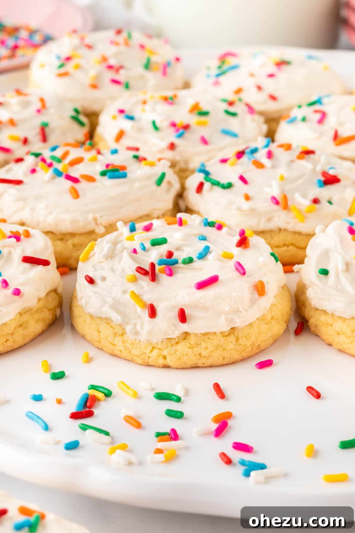 frosted cake mix sugar cookies topped with sprinkles on a tray
