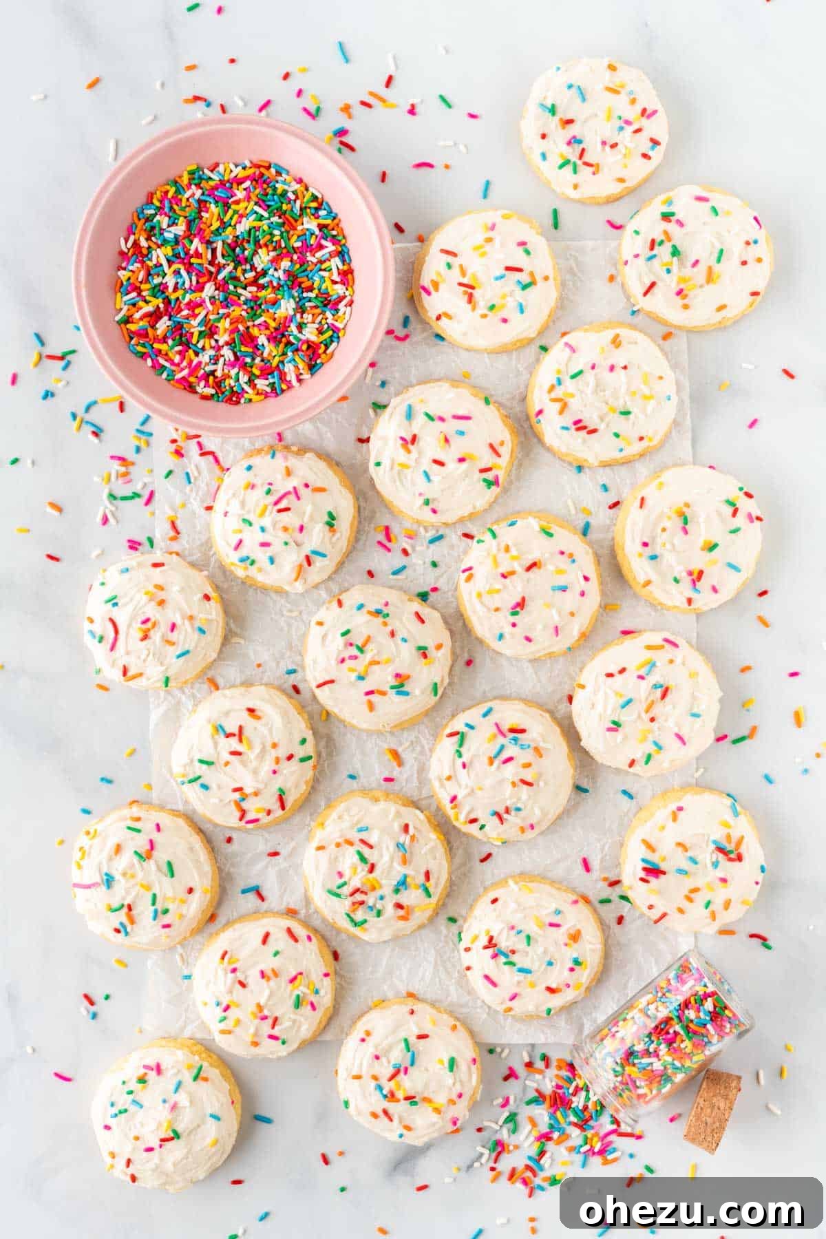 cake mix sugar cookies topped with frosting and sprinkles on a cooling rack