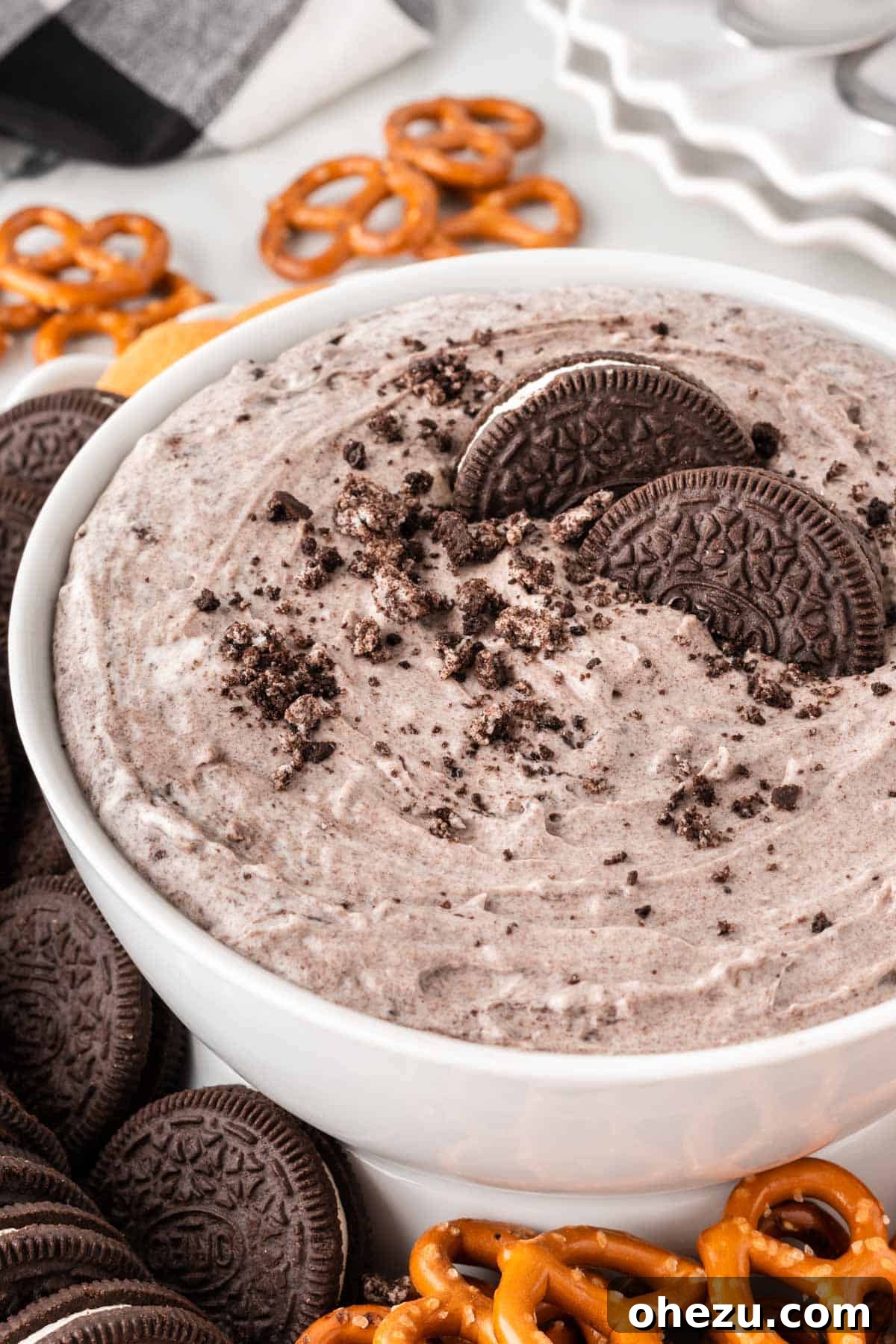 Oreo Dream Dip 11 A large bowl of Oreo Dip surrounded by an assortment of dippers: Nilla Wafers, whole Oreos, fresh strawberries, and pretzels