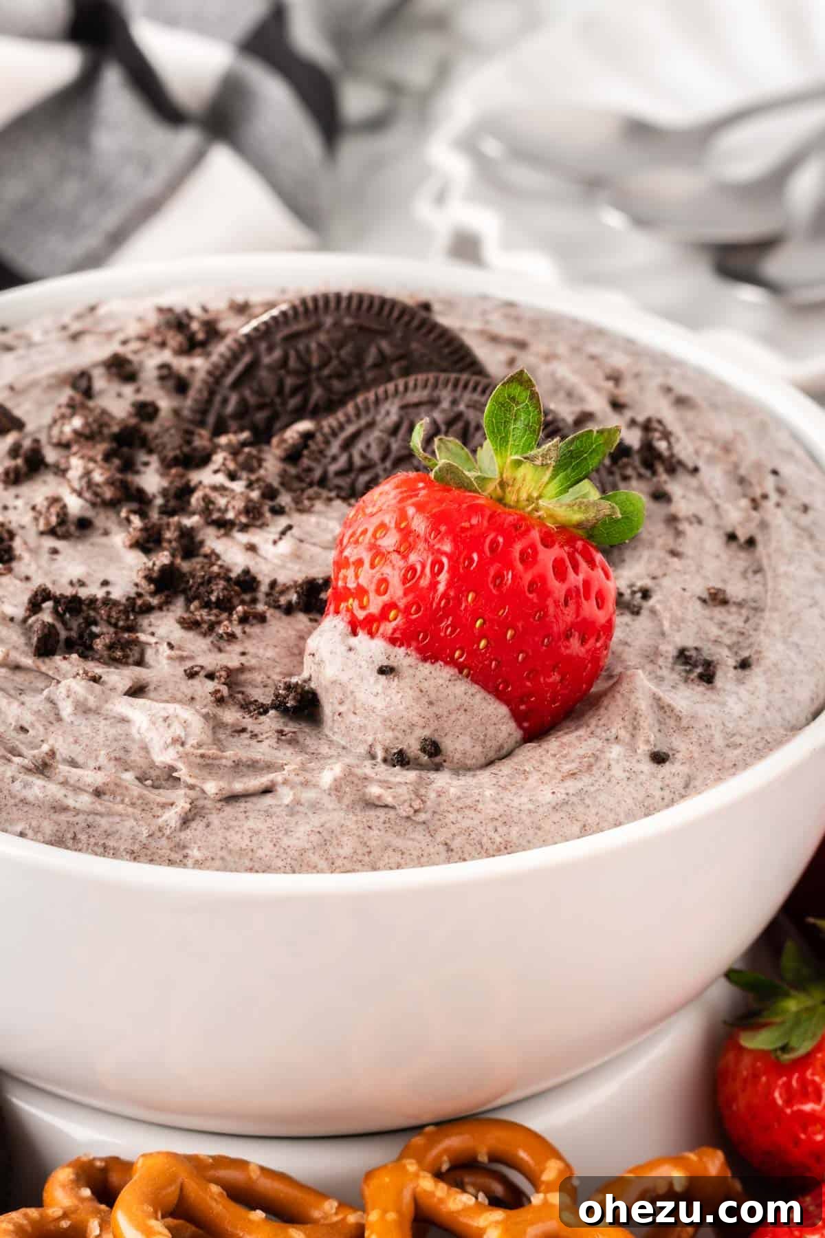 Oreo Dream Dip 12 A close-up shot of a strawberry being dipped into the rich, creamy Oreo Dip