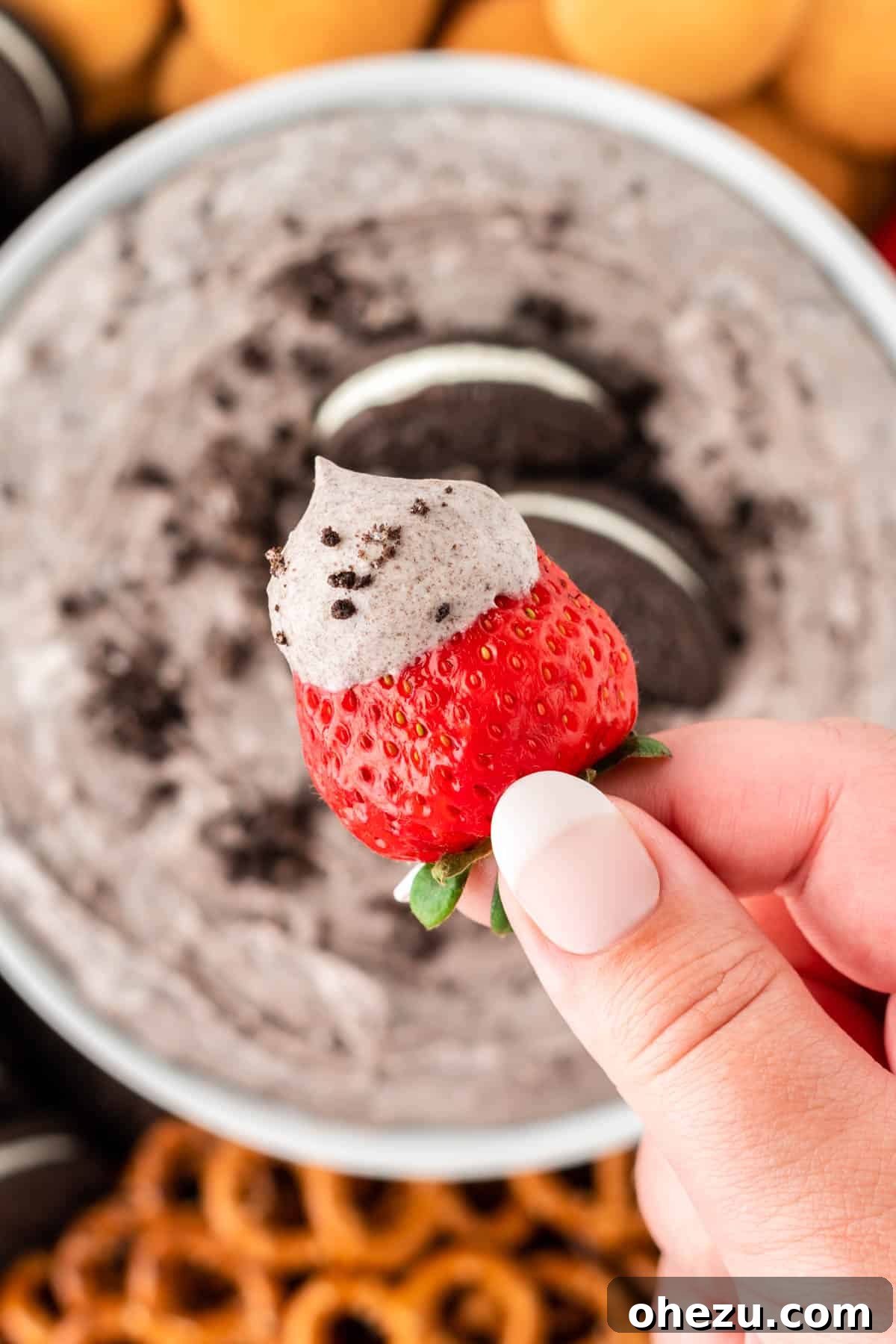 Oreo Dream Dip 3 A fresh strawberry being dipped into the creamy Oreo Dip