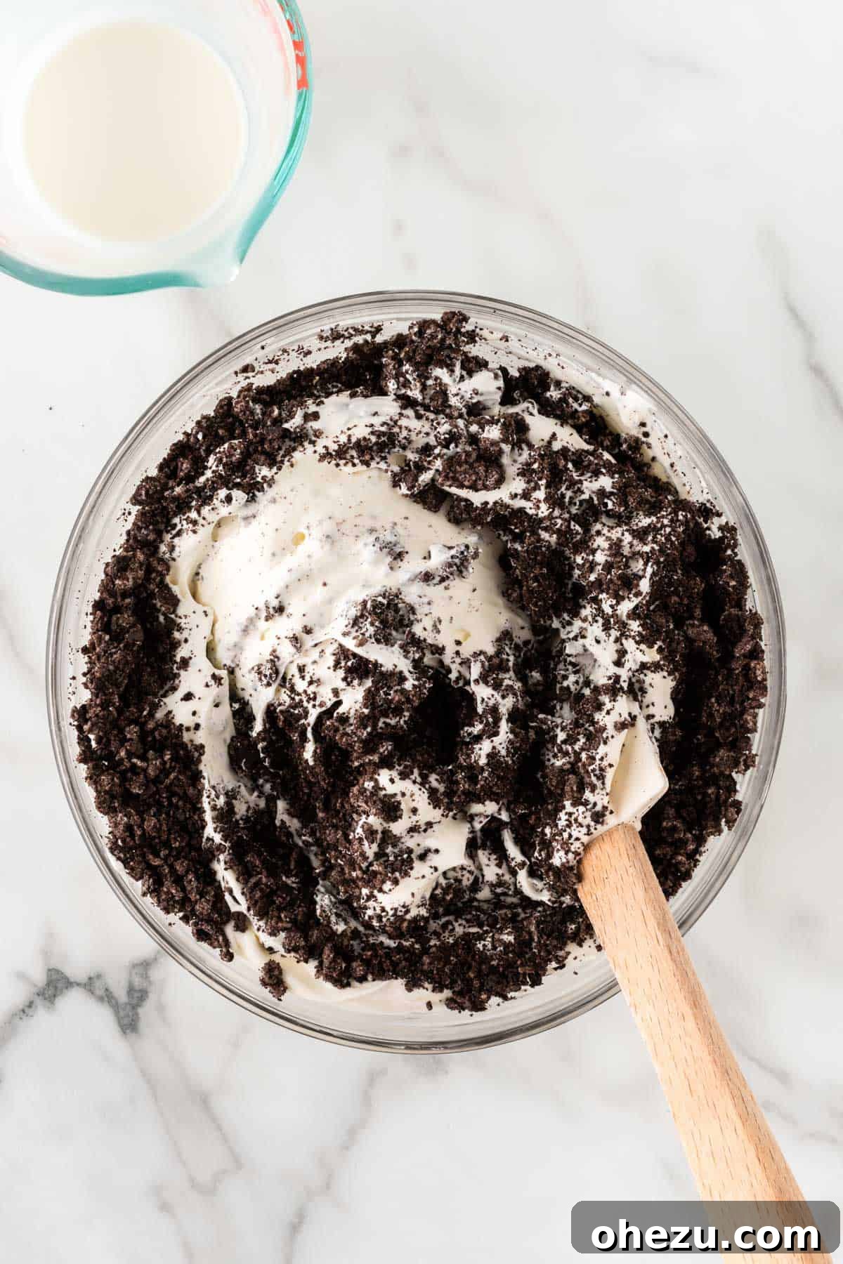 Oreo Dream Dip 8 The Oreo pieces being gently mixed into the creamy dip base with a spatula