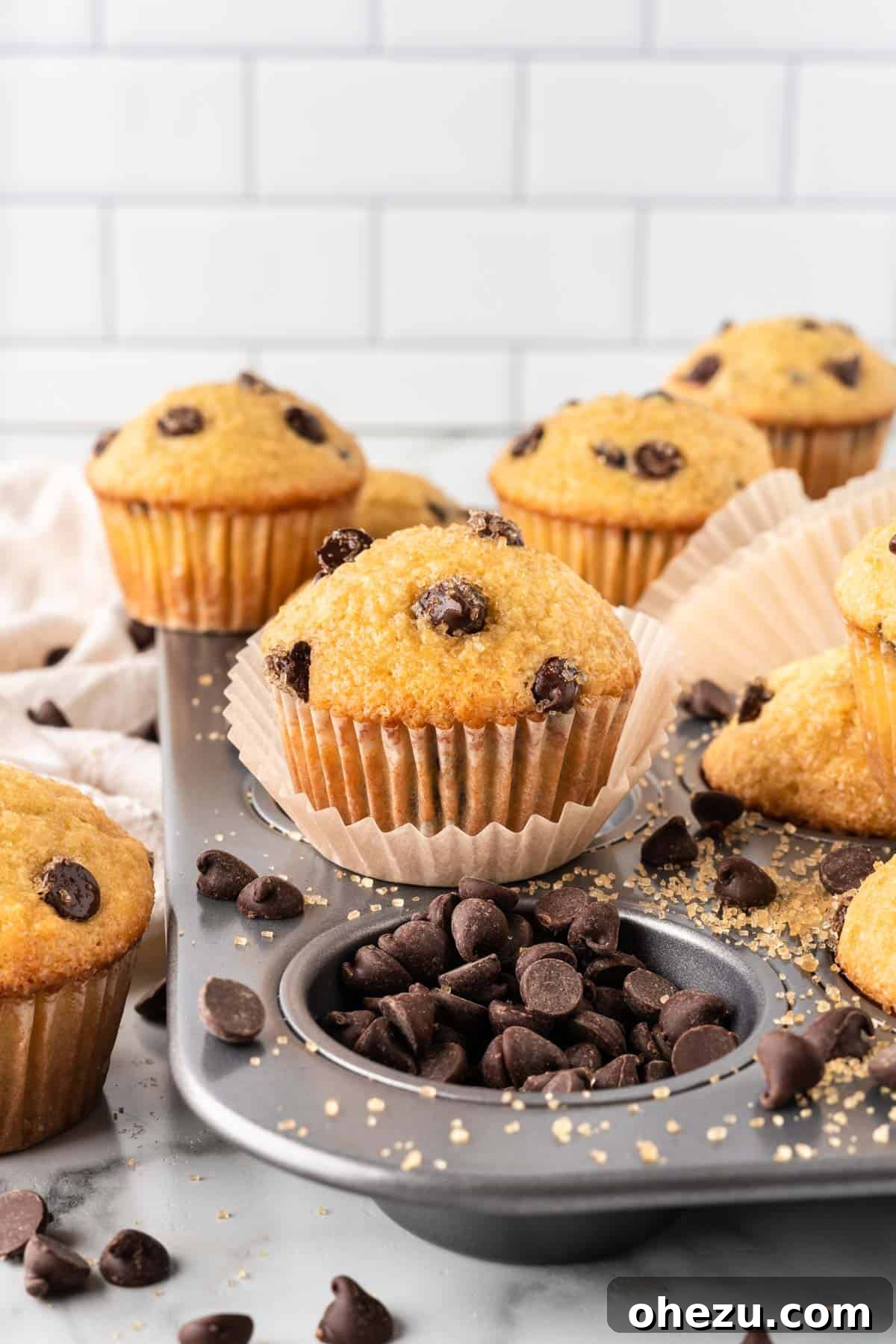 bakery style chocolate chip muffins with crackly tops