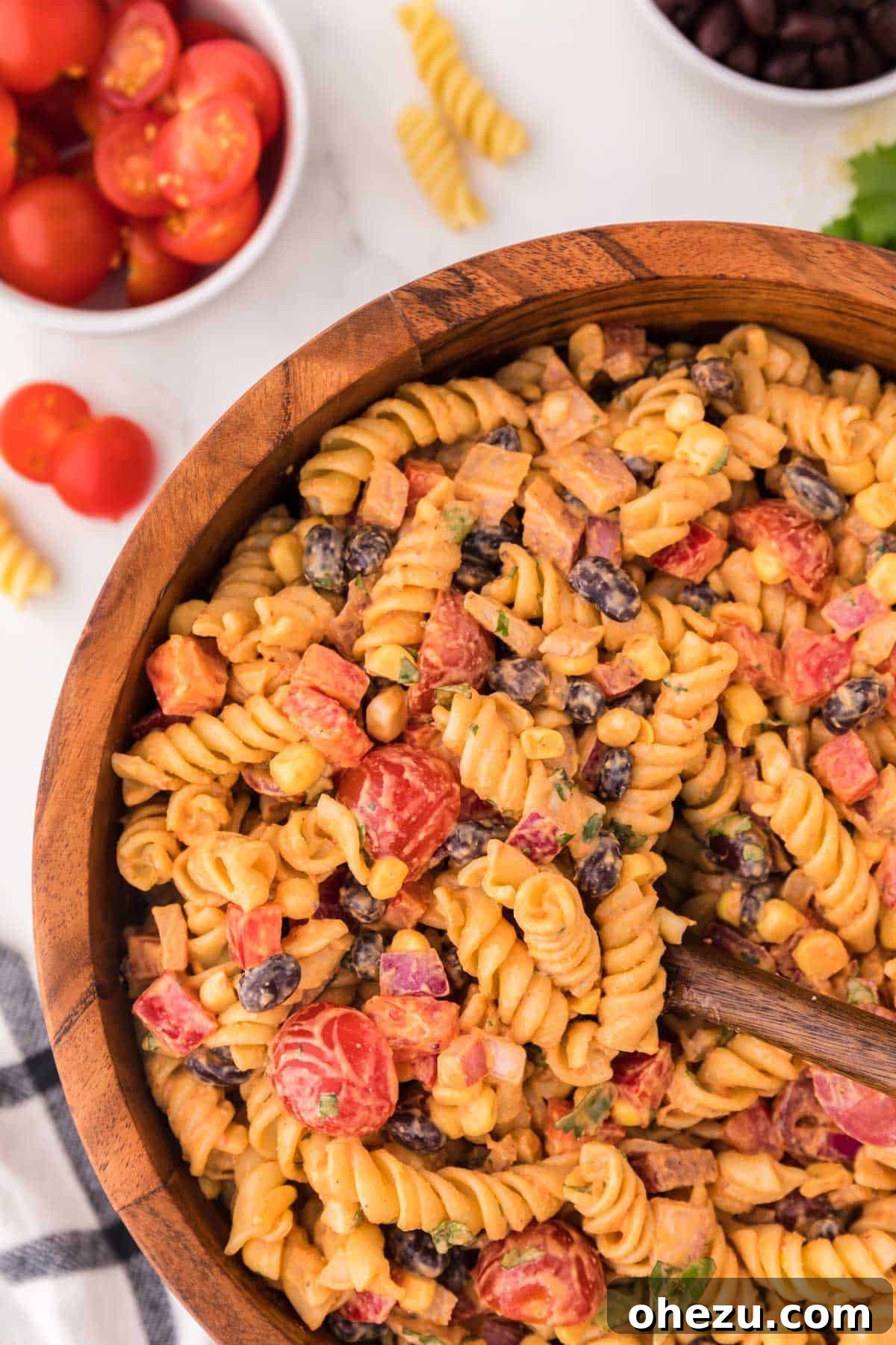 Zesty Fiesta Pasta Salad 10 A brown serving bowl filled with the fully prepared southwest pasta salad, showing the creamy dressing and colorful ingredients, ready to be served.