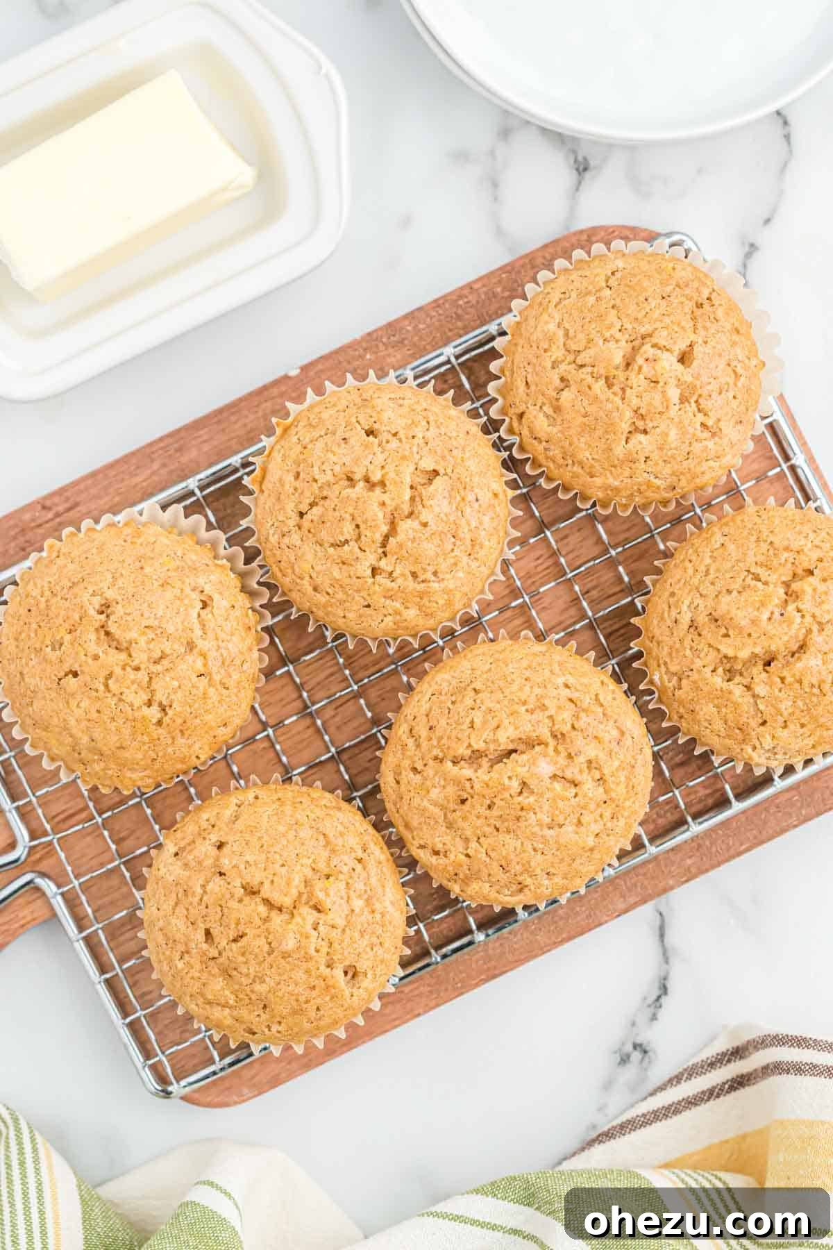 Cinnamon Apple Muffins 11 Warm applesauce muffins cooling on a wire rack, ready to be eaten