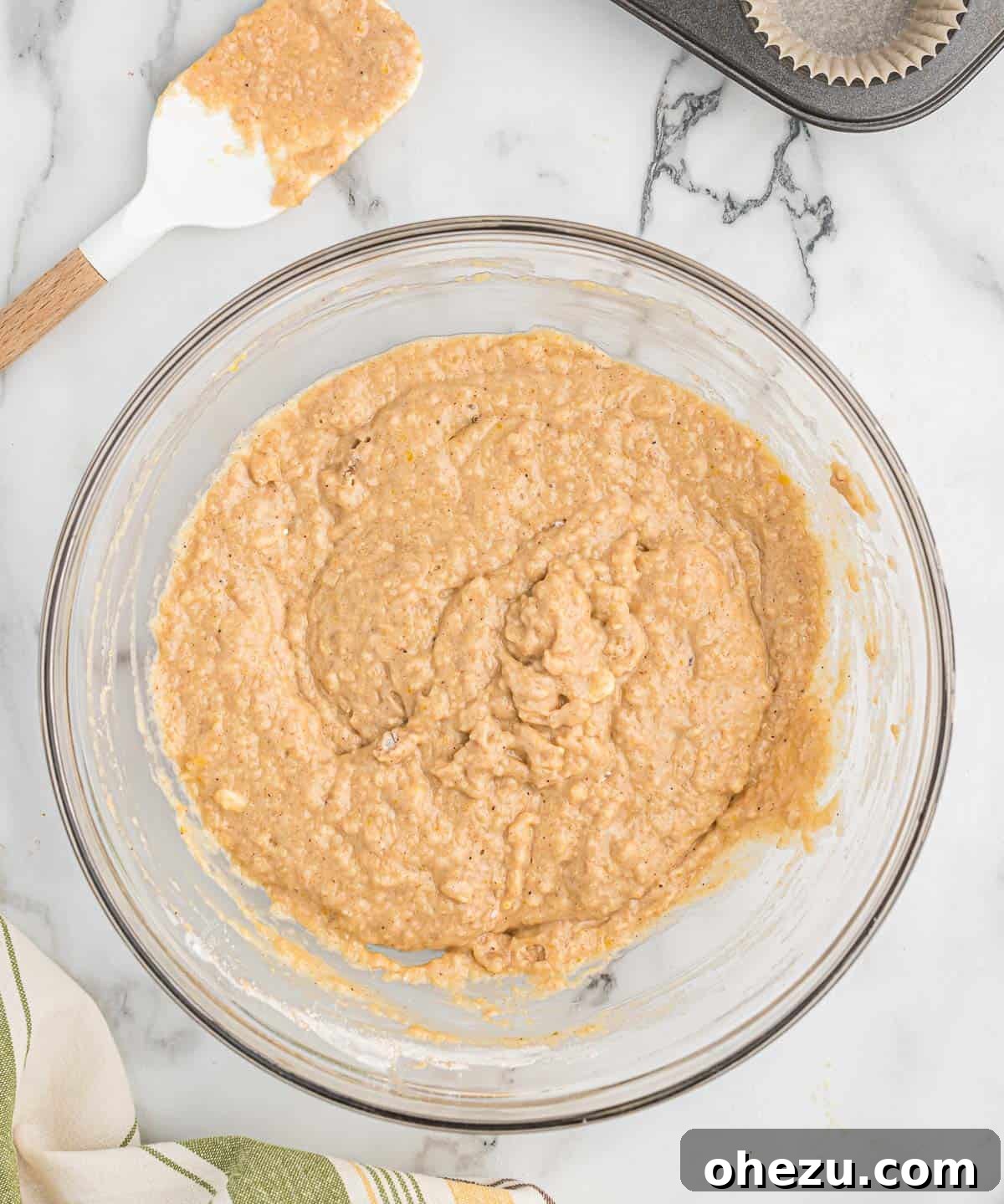 Cinnamon Apple Muffins 8 Applesauce muffin batter, perfectly mixed with some small lumps remaining, in a glass bowl