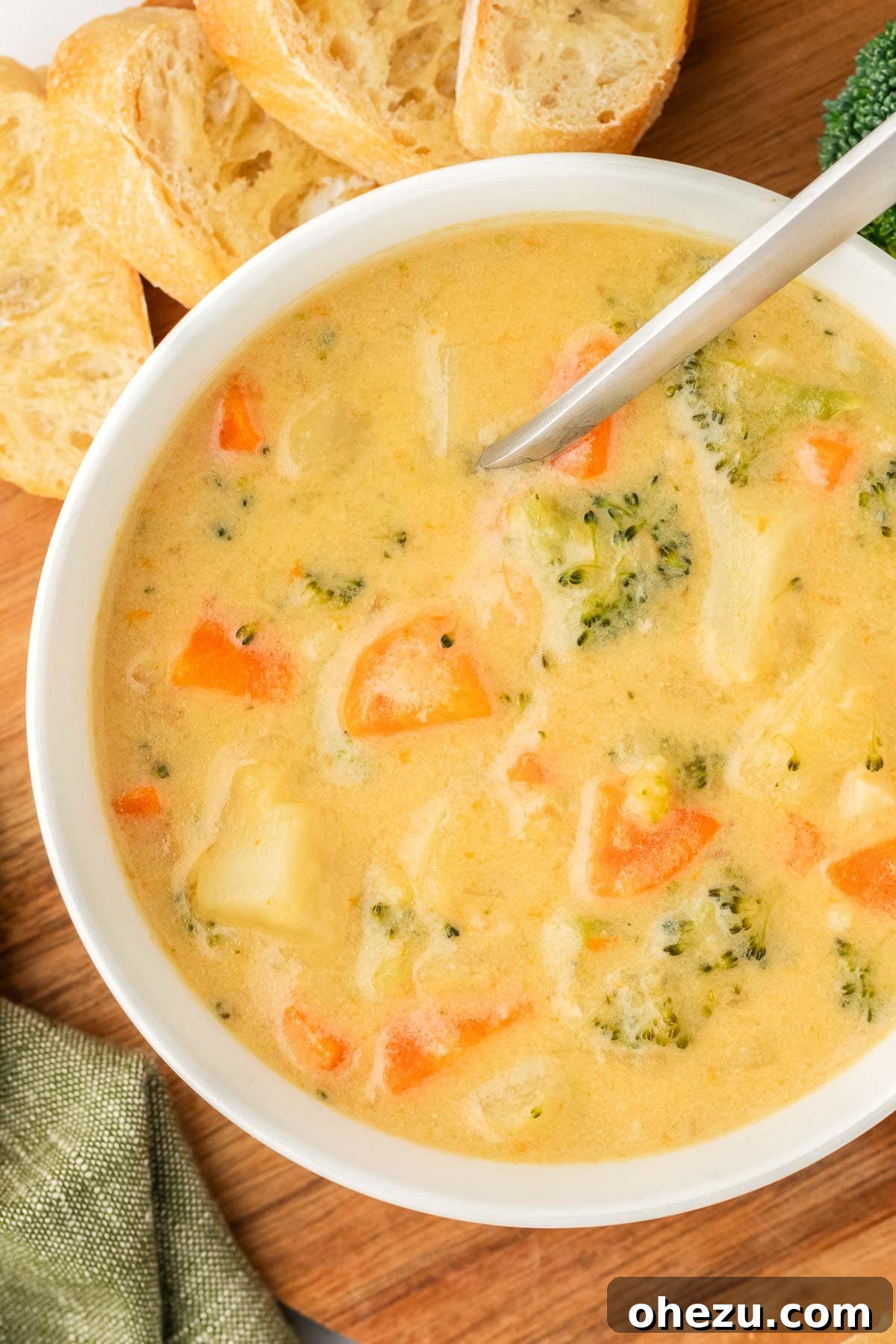 Another inviting perspective of creamy vegetable soup in a bowl with a spoon, emphasizing its rich texture and appealing presentation, ready for enjoyment.
