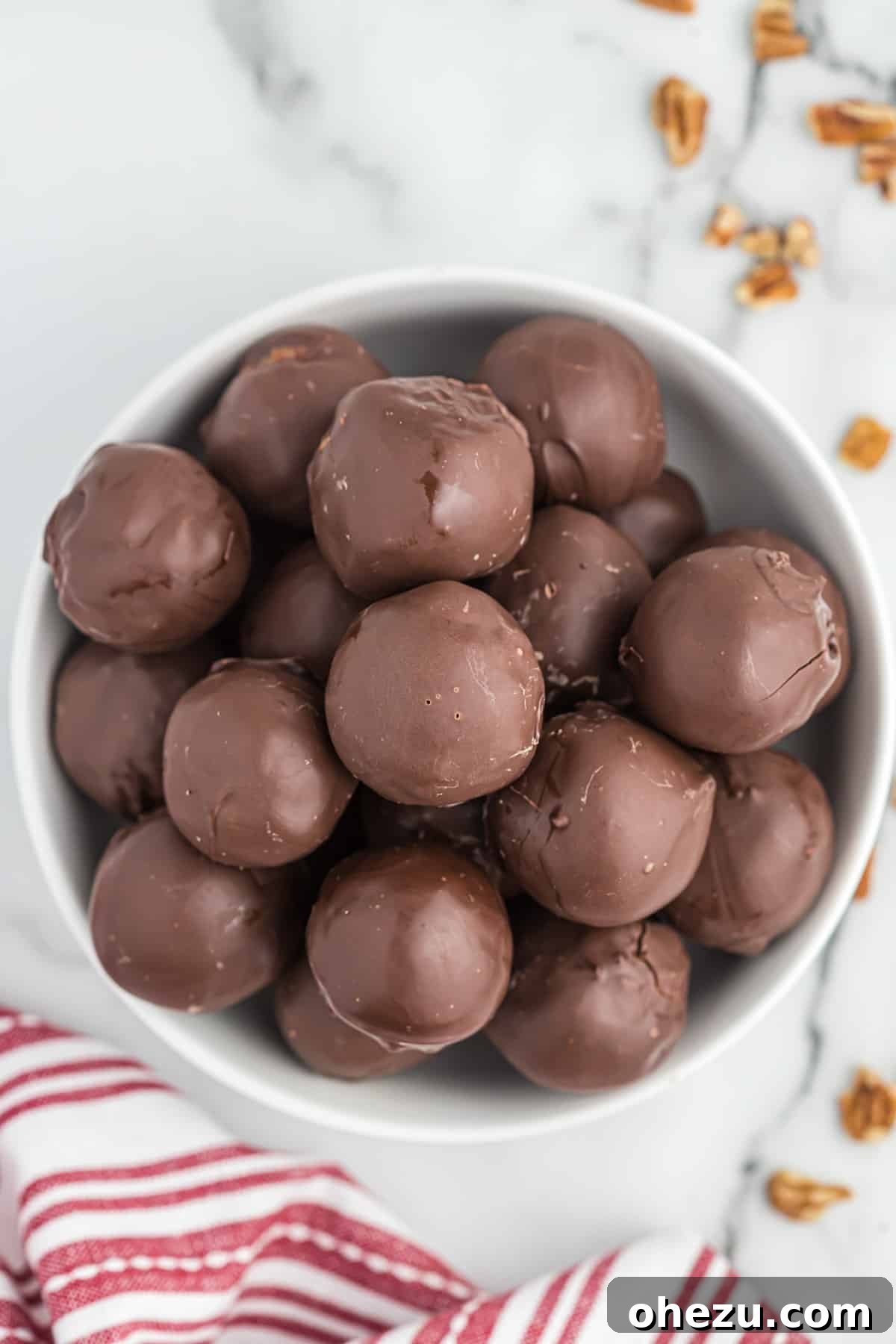 Pecan Pie Truffles 3 A bowl filled with freshly made no bake pecan pie balls, showcasing their perfectly round shape and tempting coating.