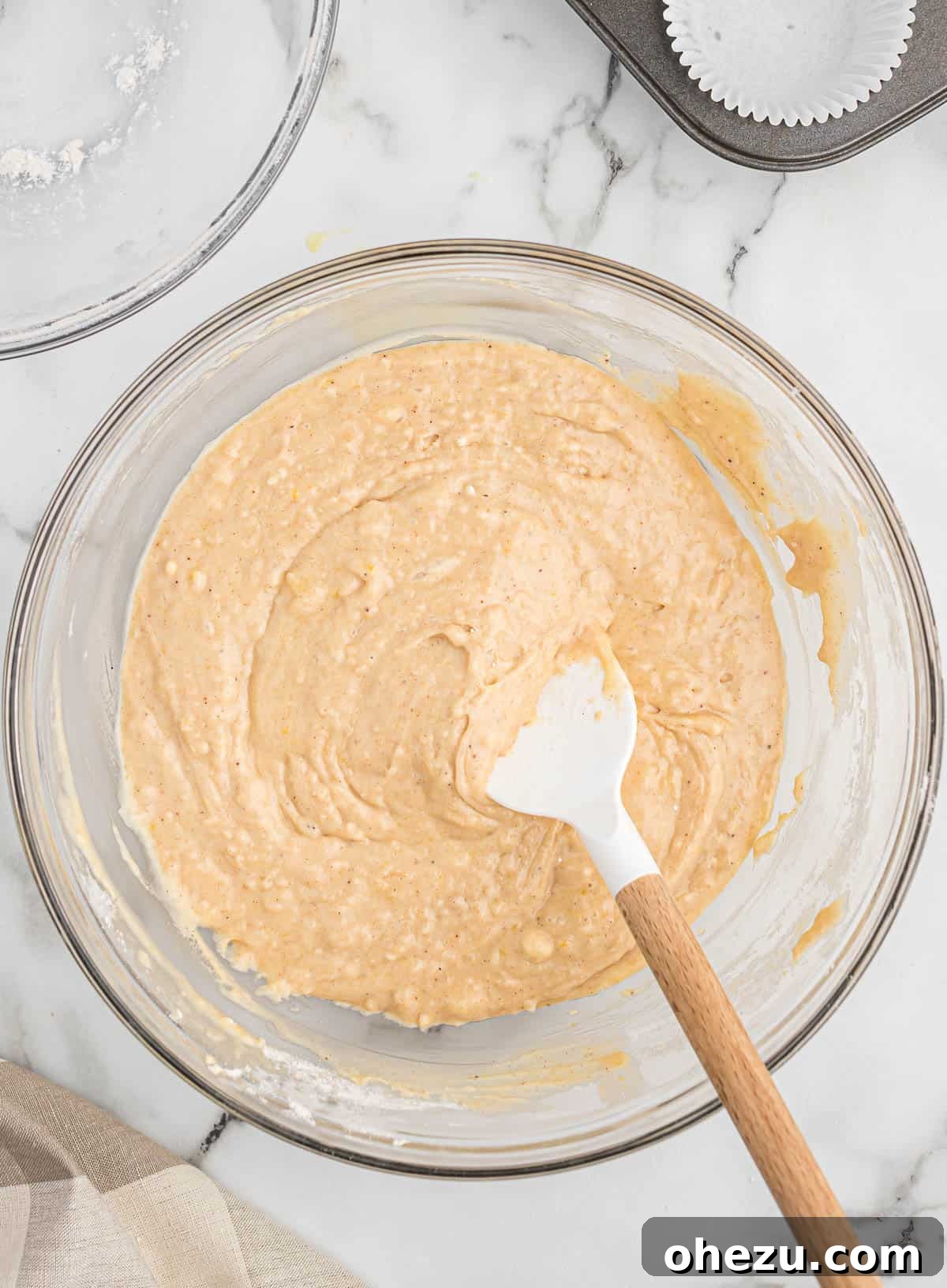 Close-up of the mixed eggnog muffin batter, showing its rich, thick consistency.