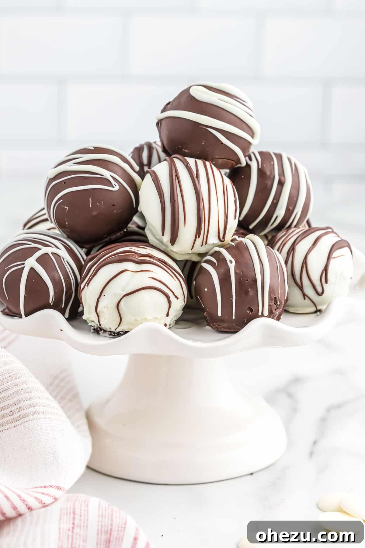 Another view of the oreo balls on a serving plate, highlighting their appealing texture and coating.