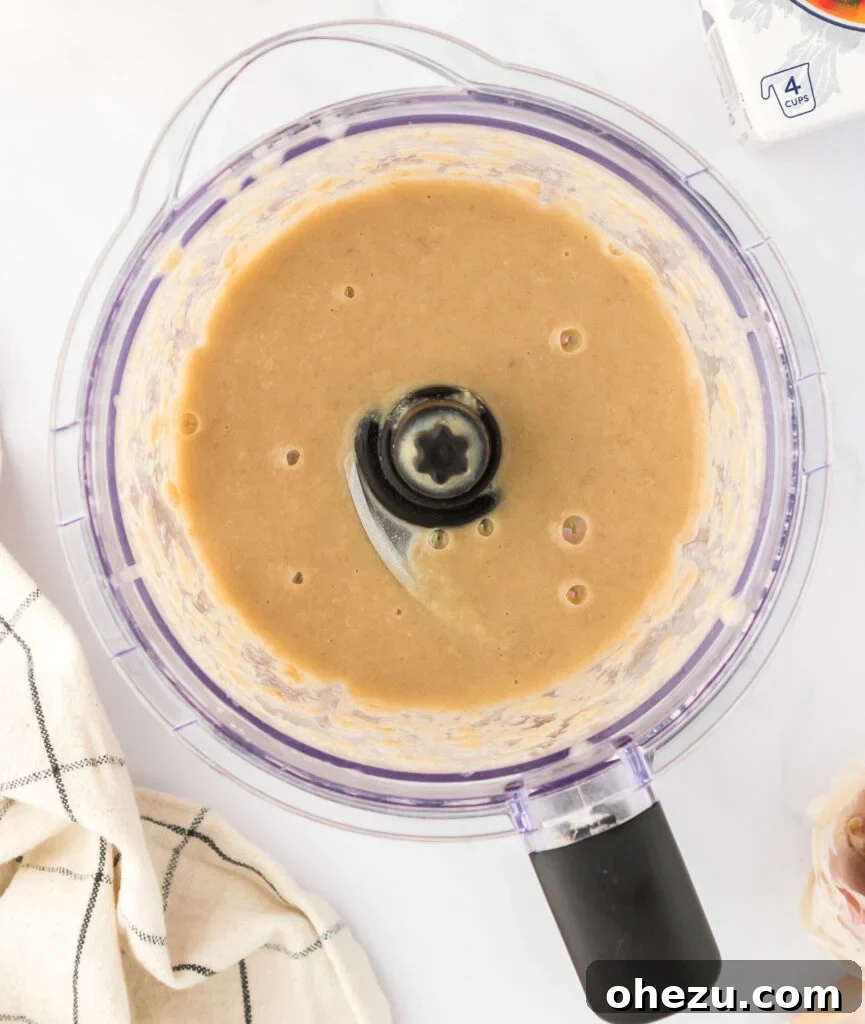 A perfectly smooth, creamy, and thick blended mushroom mixture after processing, ready to be incorporated into the gravy.