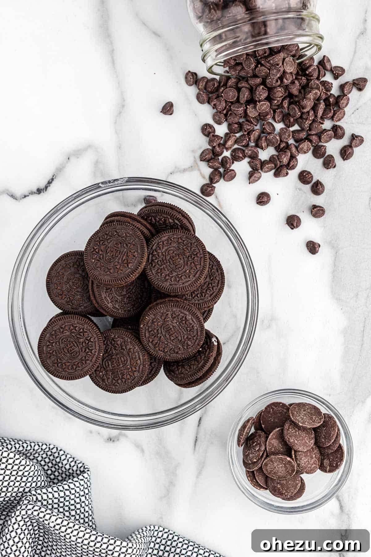 Decadent Oreo Delights 4 The essential ingredients laid out: a pack of Oreos, a bag of semi-sweet chocolate chips, and dark chocolate melting wafers.
