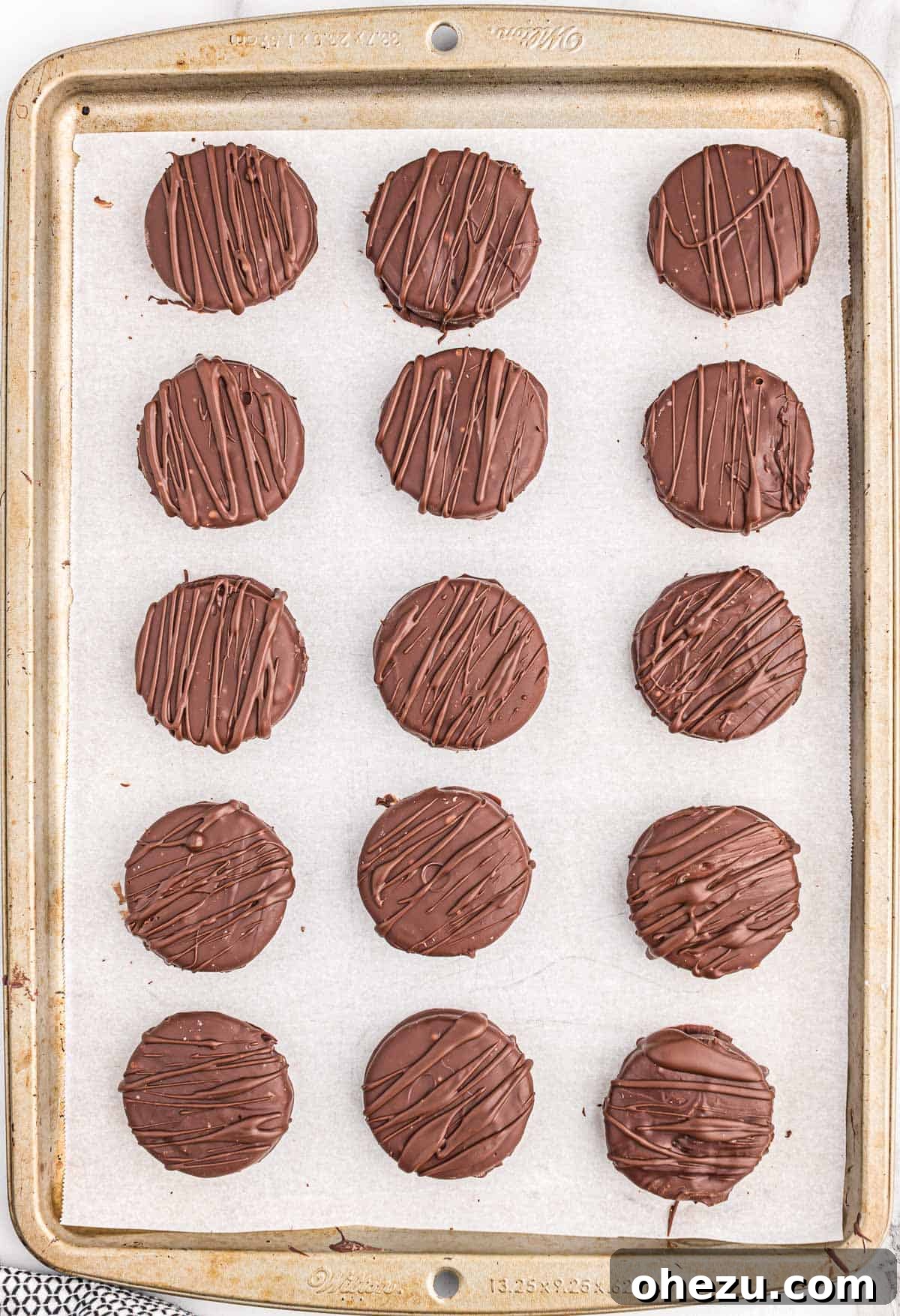 Decadent Oreo Delights 7 Another tray showing chocolate-drizzled Oreos, now with an elegant decorative touch, ready for their final chill.
