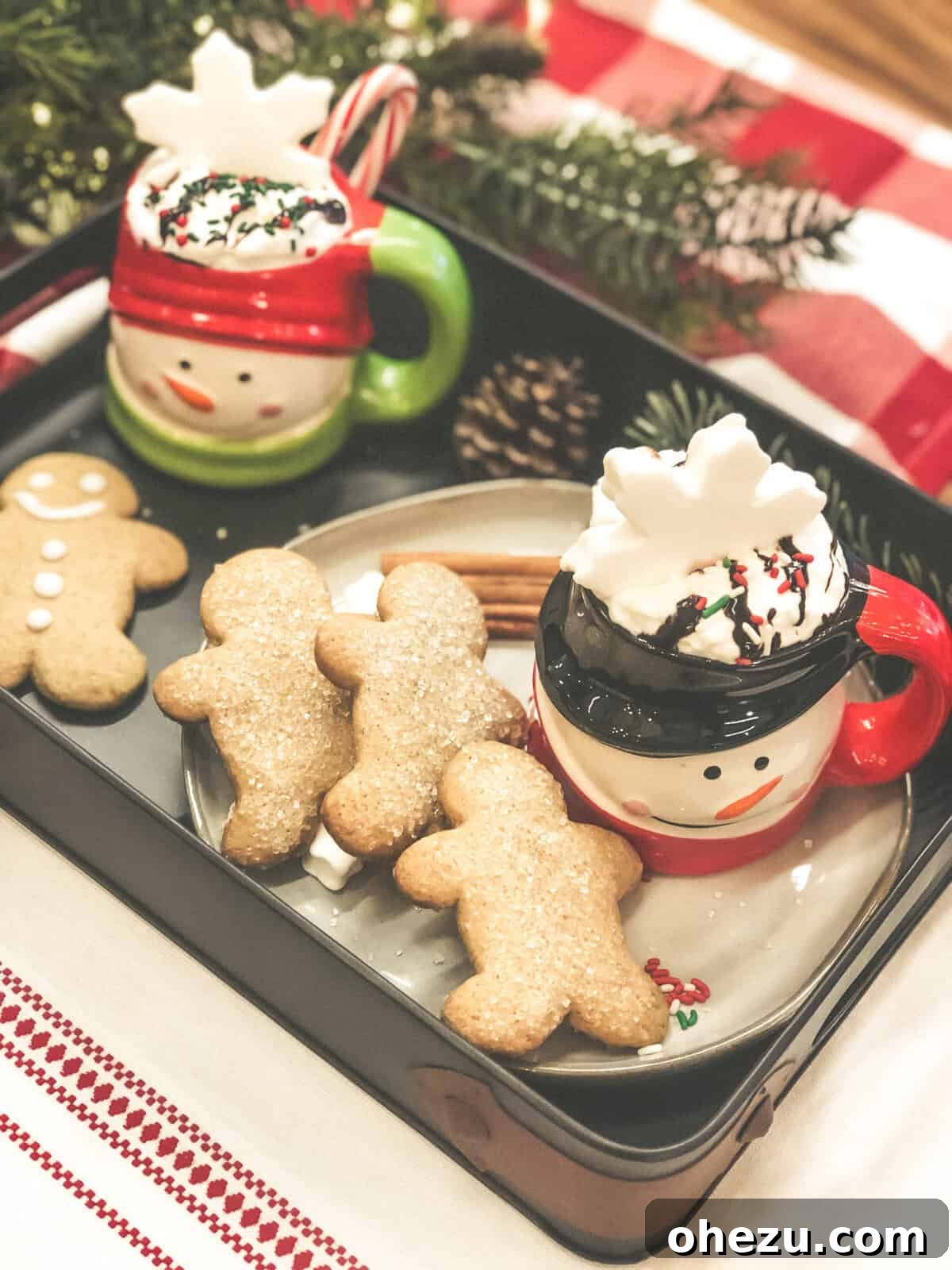 Collection of items for a holiday cocoa and cookies gift basket, including mugs, mixes, and sweets.