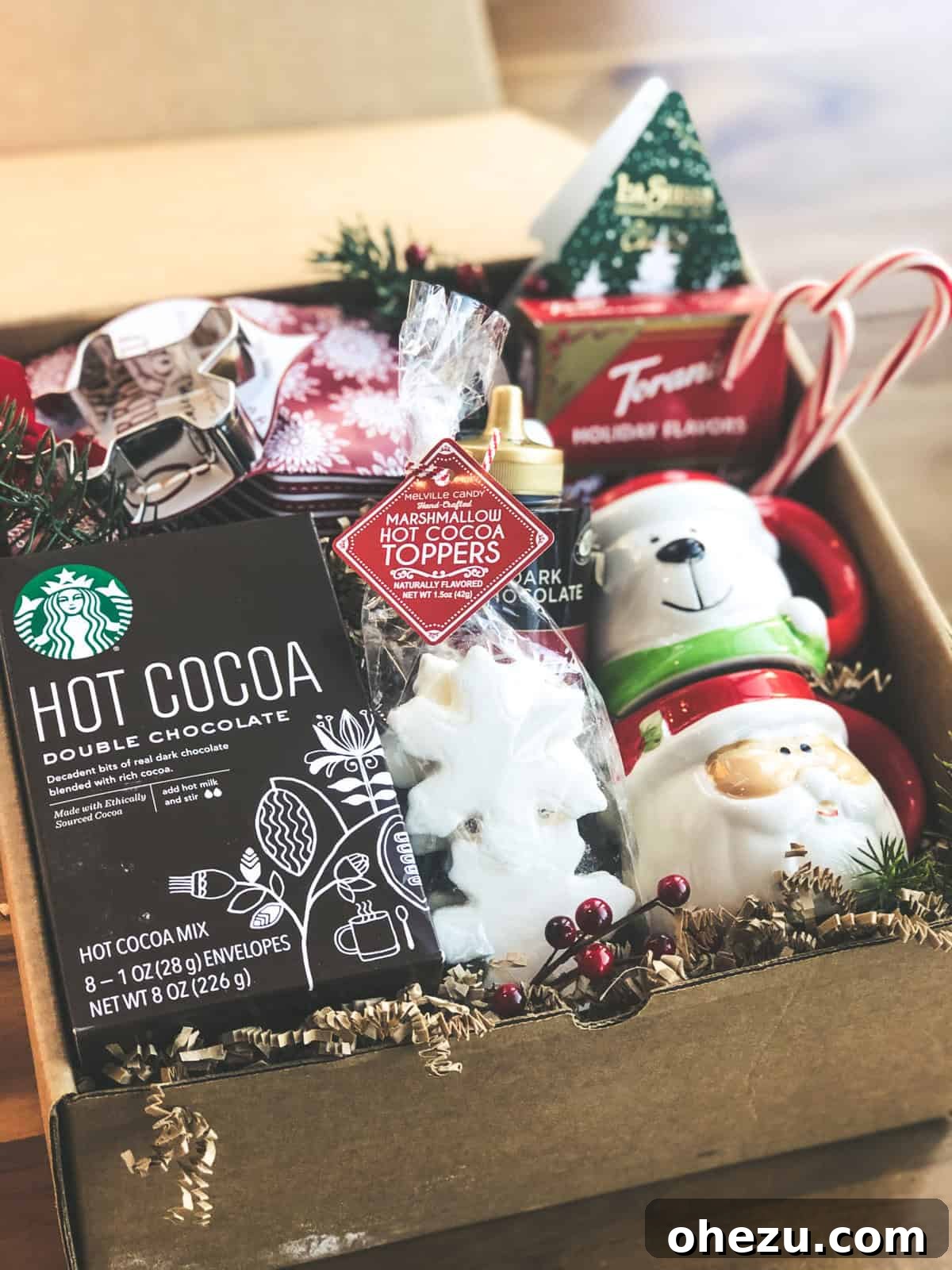 Close-up of cocoa and cookie ingredients laid out, featuring gingerbread mix and various chocolates.