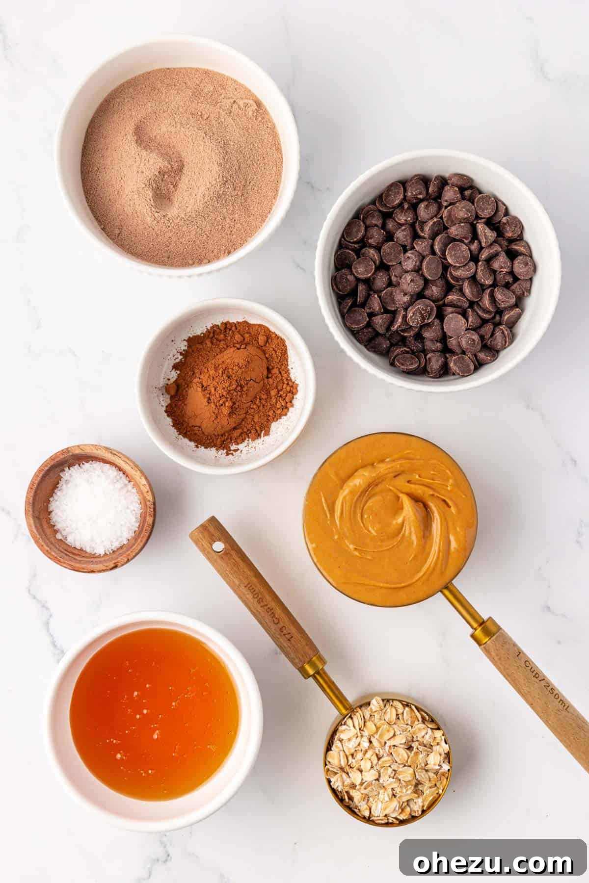 A selection of ingredients laid out on a table, ready to make chocolate protein bars.