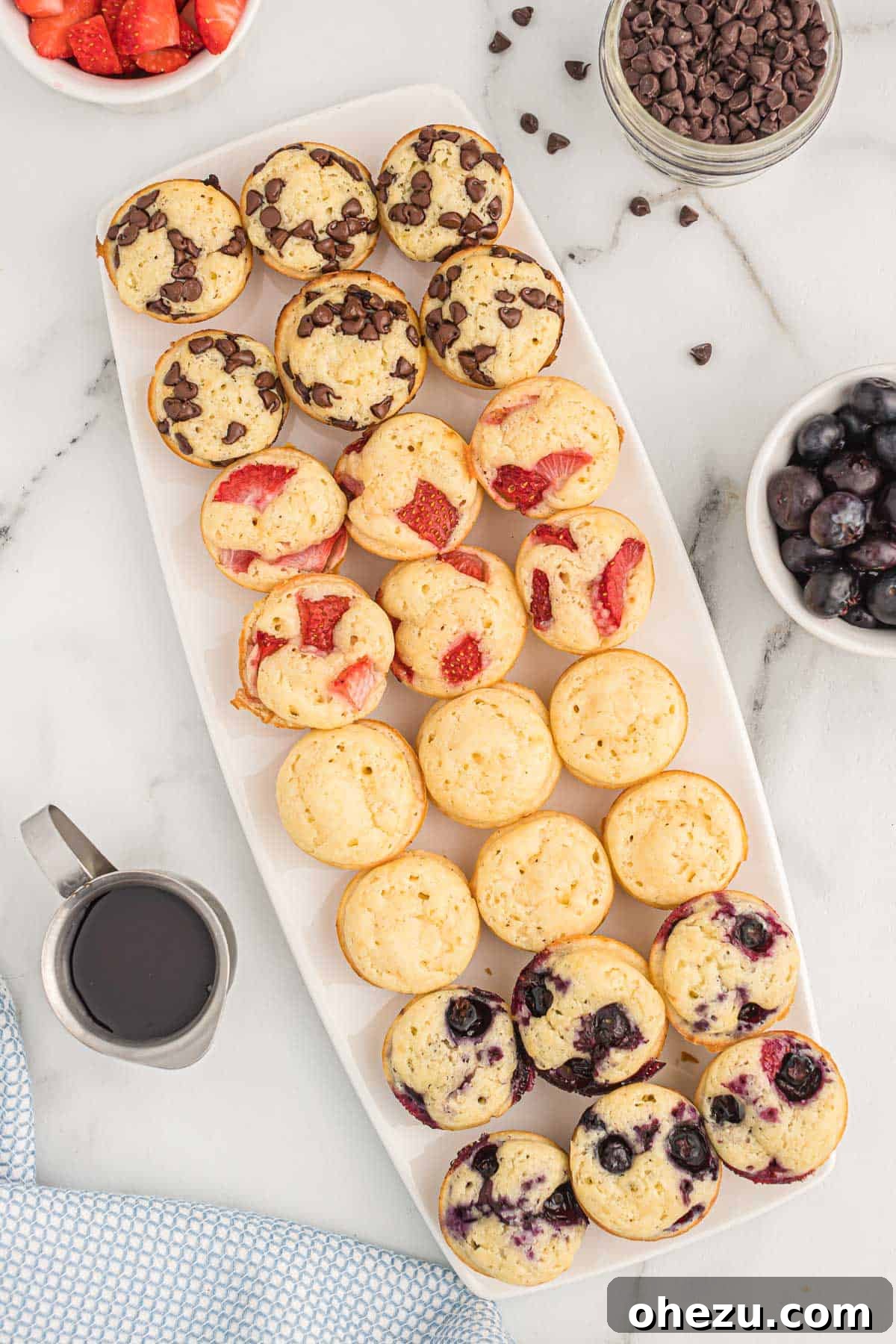Baked Pancake Bites 11 Freshly baked pancake mini muffins on a white platter, steam subtly rising, ready to be enjoyed