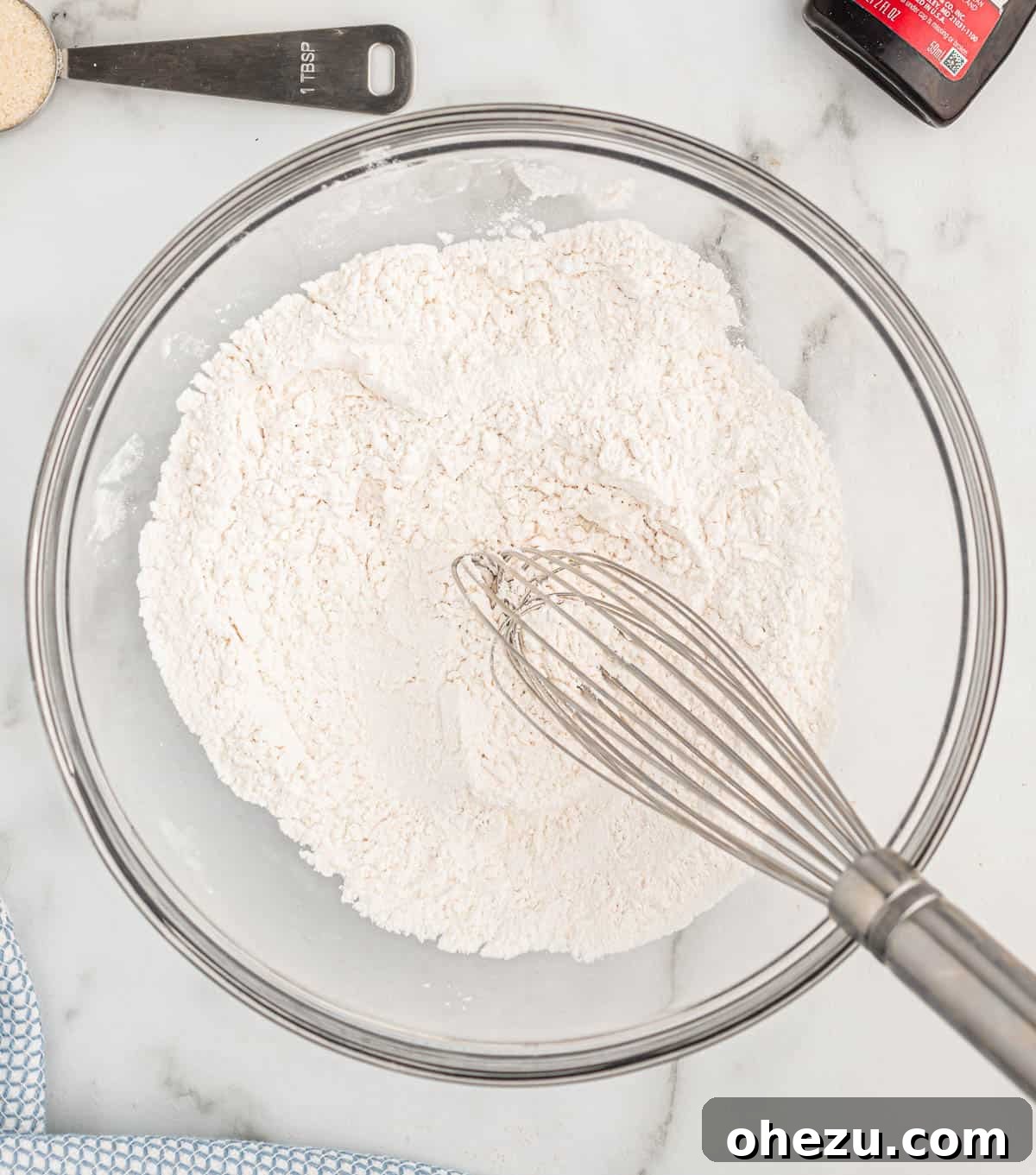 Baked Pancake Bites 5 Dry ingredients like flour, baking powder, and salt are whisked together in a white mixing bowl
