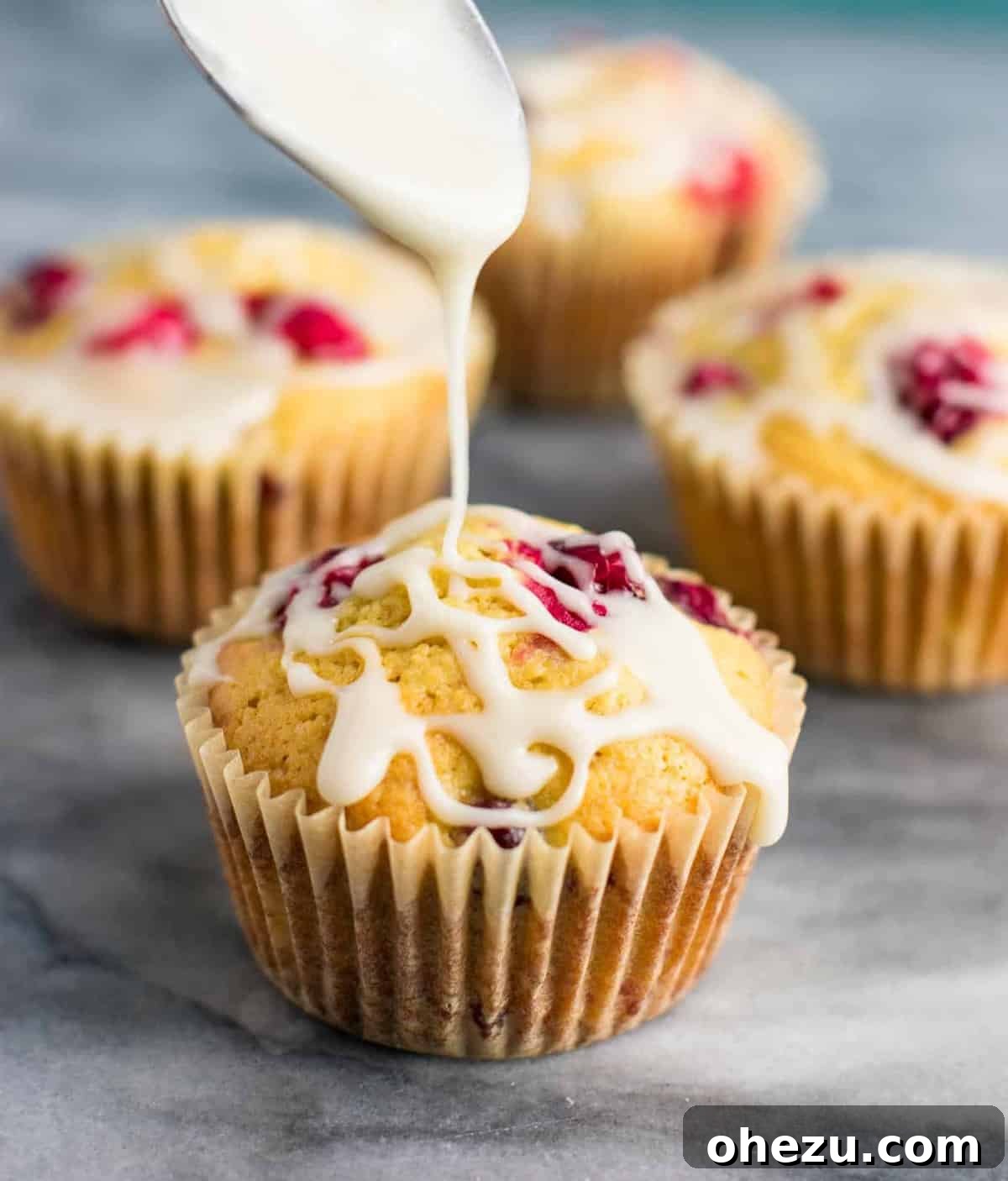 Freshly baked cranberry cream cheese muffins with a sweet glaze, perfect for a cozy Christmas breakfast.