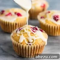 Delicious Cranberry Cream Cheese Muffins with a sweet glaze.