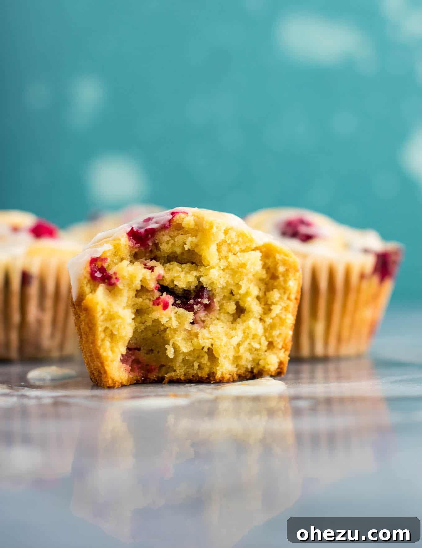 Several cranberry cream cheese muffins on a wooden board, ready to be served for breakfast.