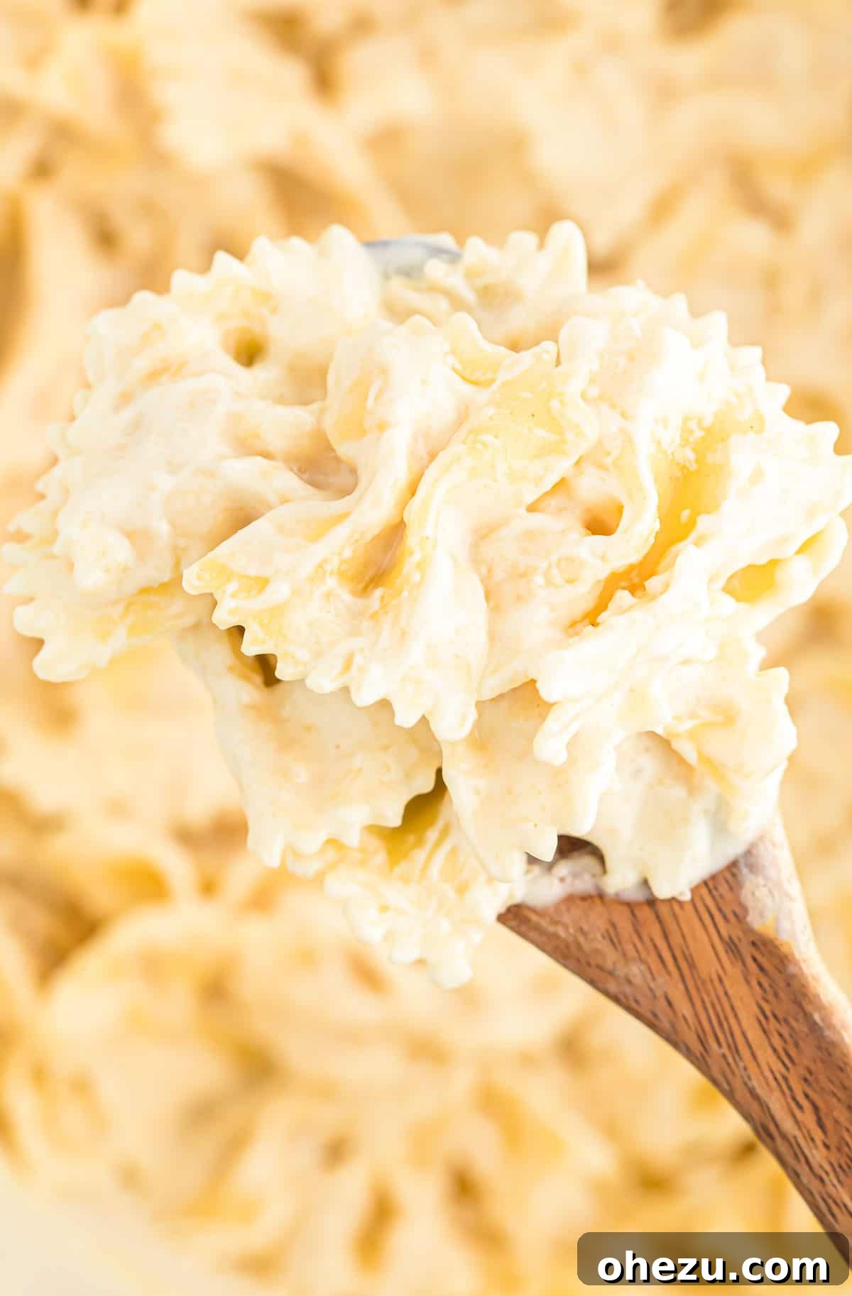 Delicious Parmesan cream sauce generously coating pasta, ready to be served.