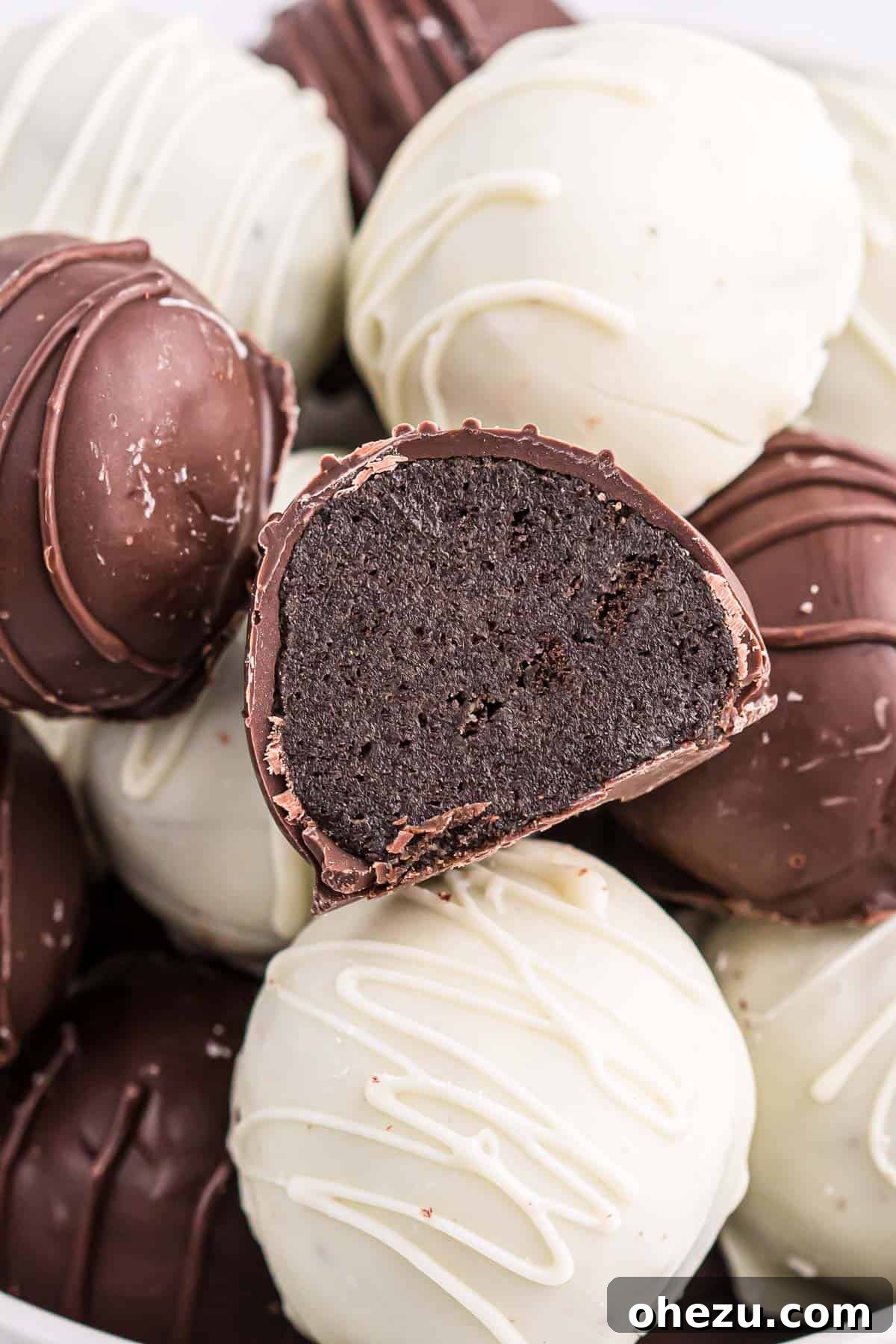 Emerald Oreo Delights 2 A perfectly halved Mint Oreo truffle revealing its luscious cream cheese and Oreo crumb filling, coated in rich dark chocolate.