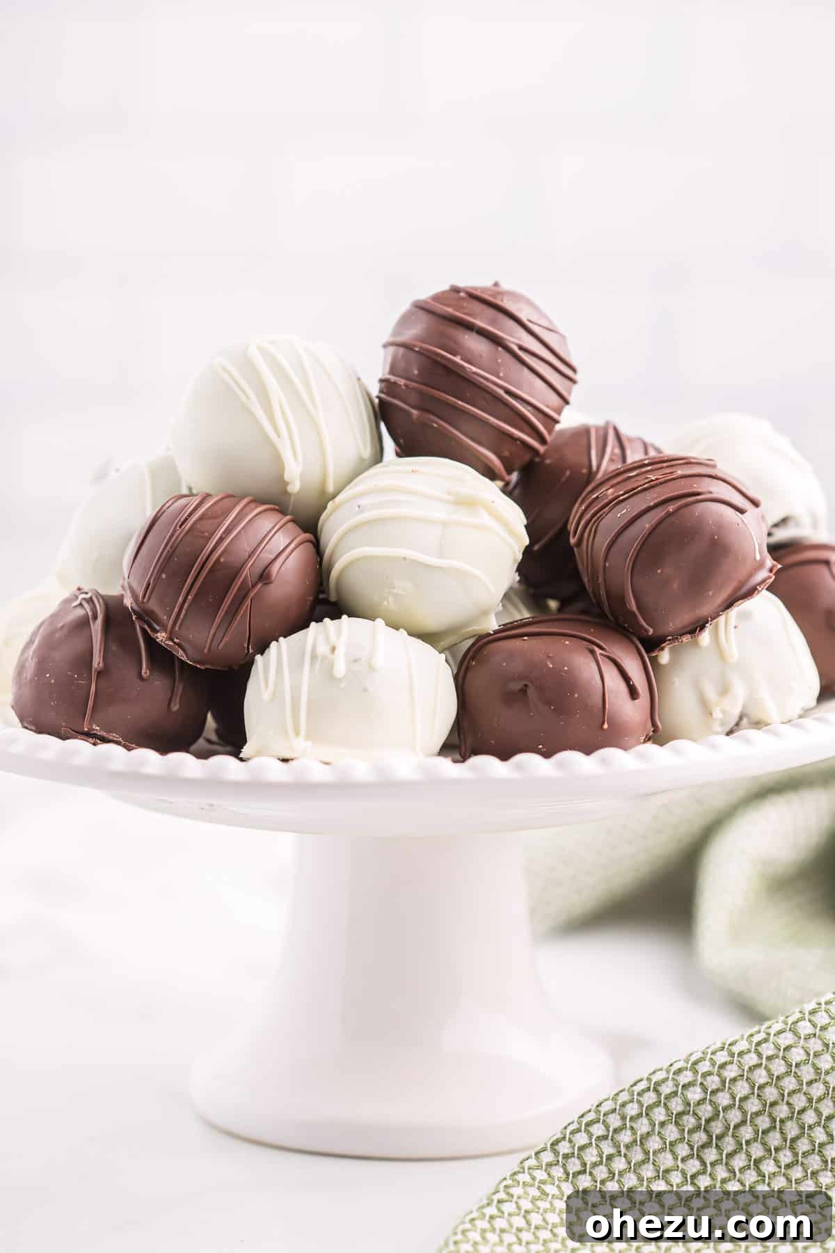 Emerald Oreo Delights 12 A vibrant dessert platter brimming with an assortment of dark and white chocolate Mint Oreo truffles, beautifully arranged for serving.