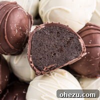 A Mint Oreo truffle cut in half to show its creamy filling and chocolate coating.