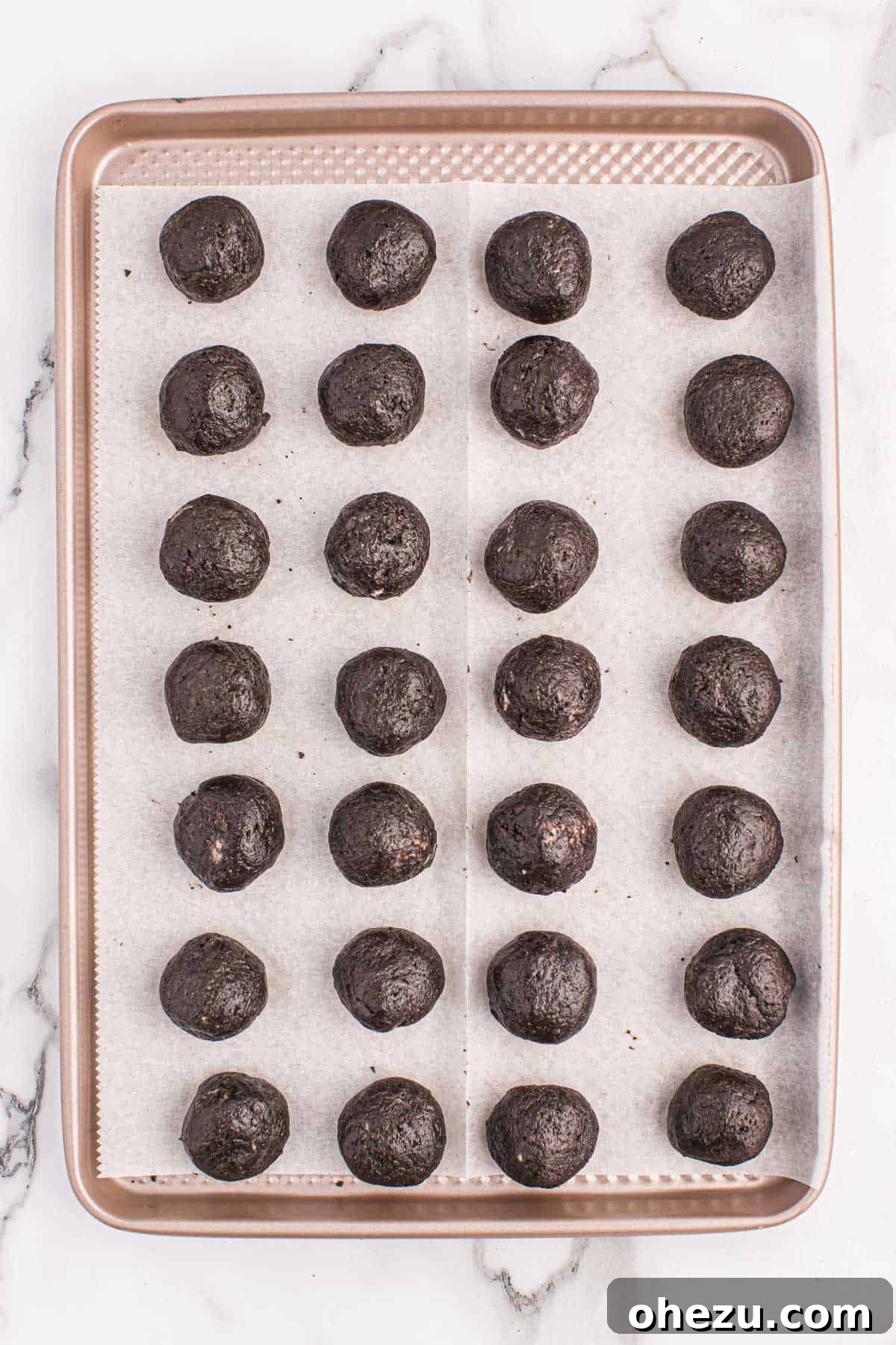 Emerald Oreo Delights 7 Approximately 24 perfectly rolled Mint Oreo balls neatly arranged on a parchment-lined baking sheet, ready for chilling.