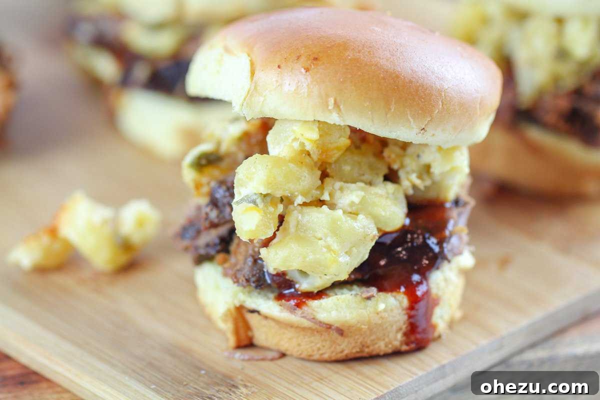 Smoky BBQ Brisket Sliders with Spicy Jalapeno Mac and Cheese 4 Platter of BBQ Sliders with Creamy Jalapeno Mac & Cheese, garnished with fresh herbs