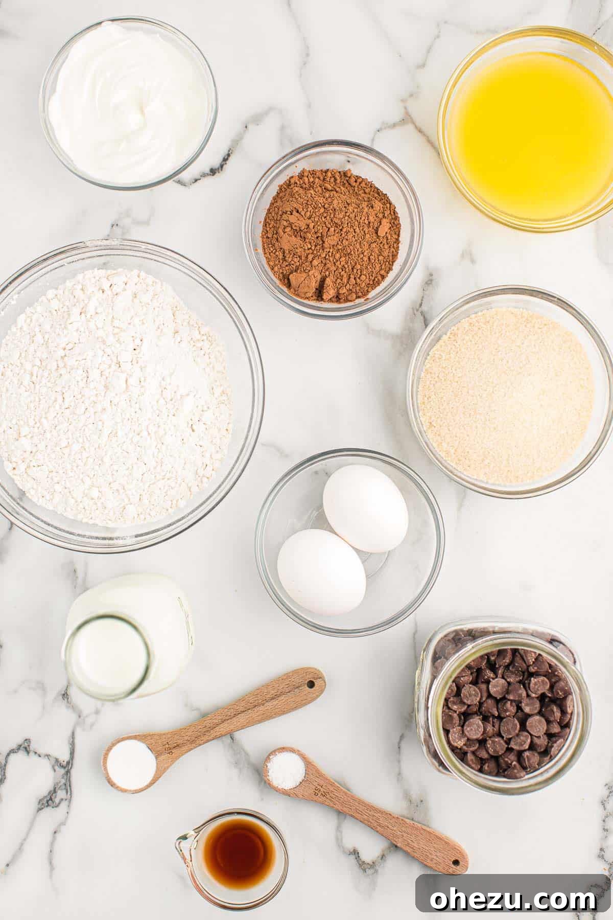 Chocolate Indulgence Muffins 4 All the dry and wet ingredients laid out on a kitchen counter, ready to be combined for making chocolate muffins.