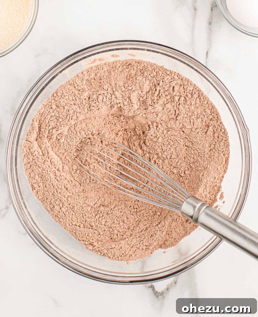 Chocolate Indulgence Muffins 5 Dry ingredients (flour, cocoa powder, baking soda, salt) perfectly mixed together in a large mixing bowl.
