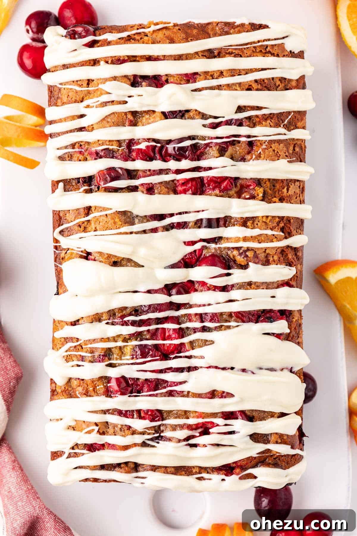 Another view of the moist cranberry eggnog bread with white chocolate glaze, ready to be sliced.