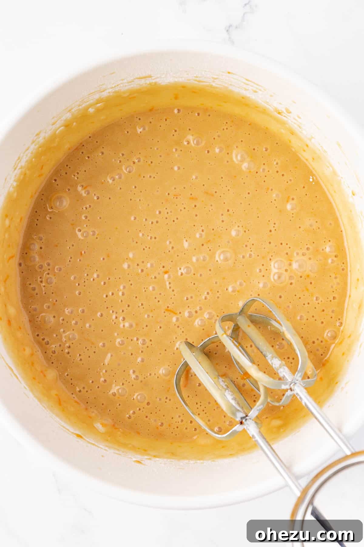 Fully combined batter in a mixing bowl, smooth and ready for cranberries.