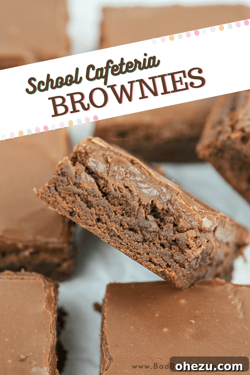 A close-up of a perfectly cut School Cafeteria Brownie, revealing its rich, fudgy interior and smooth frosting.