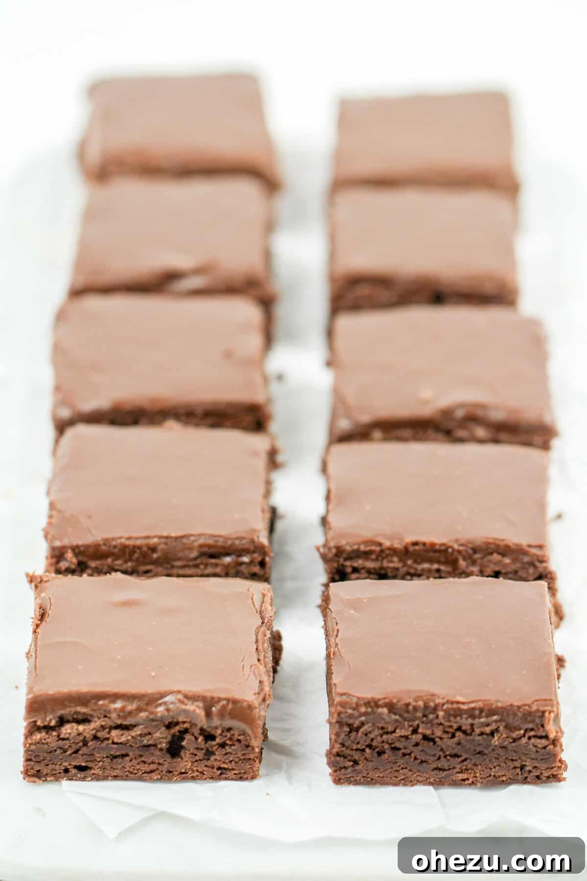Nostalgic School Brownies 5 A stack of delicious School Cafeteria Brownies, showcasing the iconic thick fudge frosting.