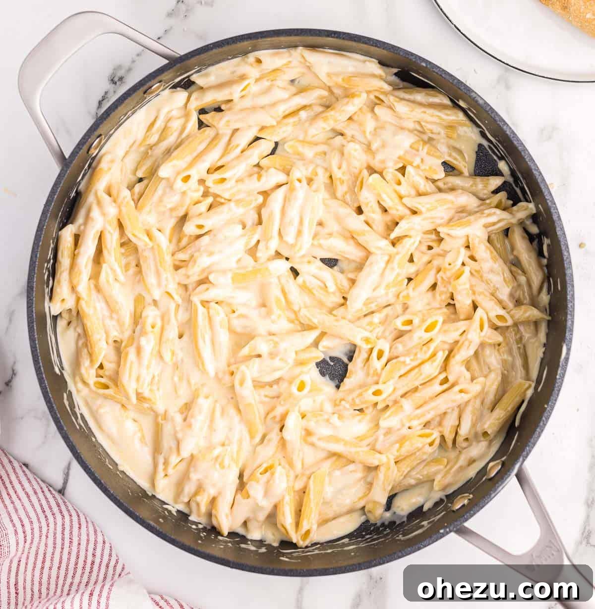 creamy penne pasta in a skillet