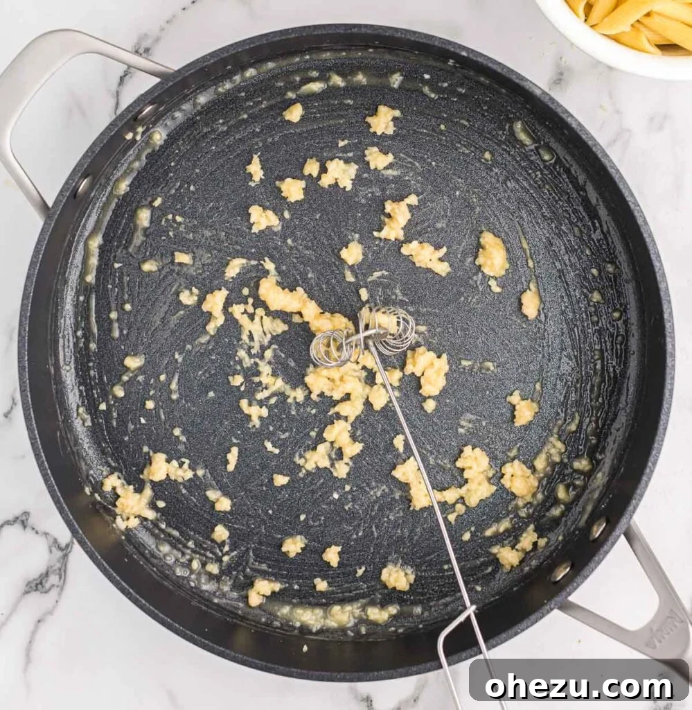 whisking flour into minced garlic and butter