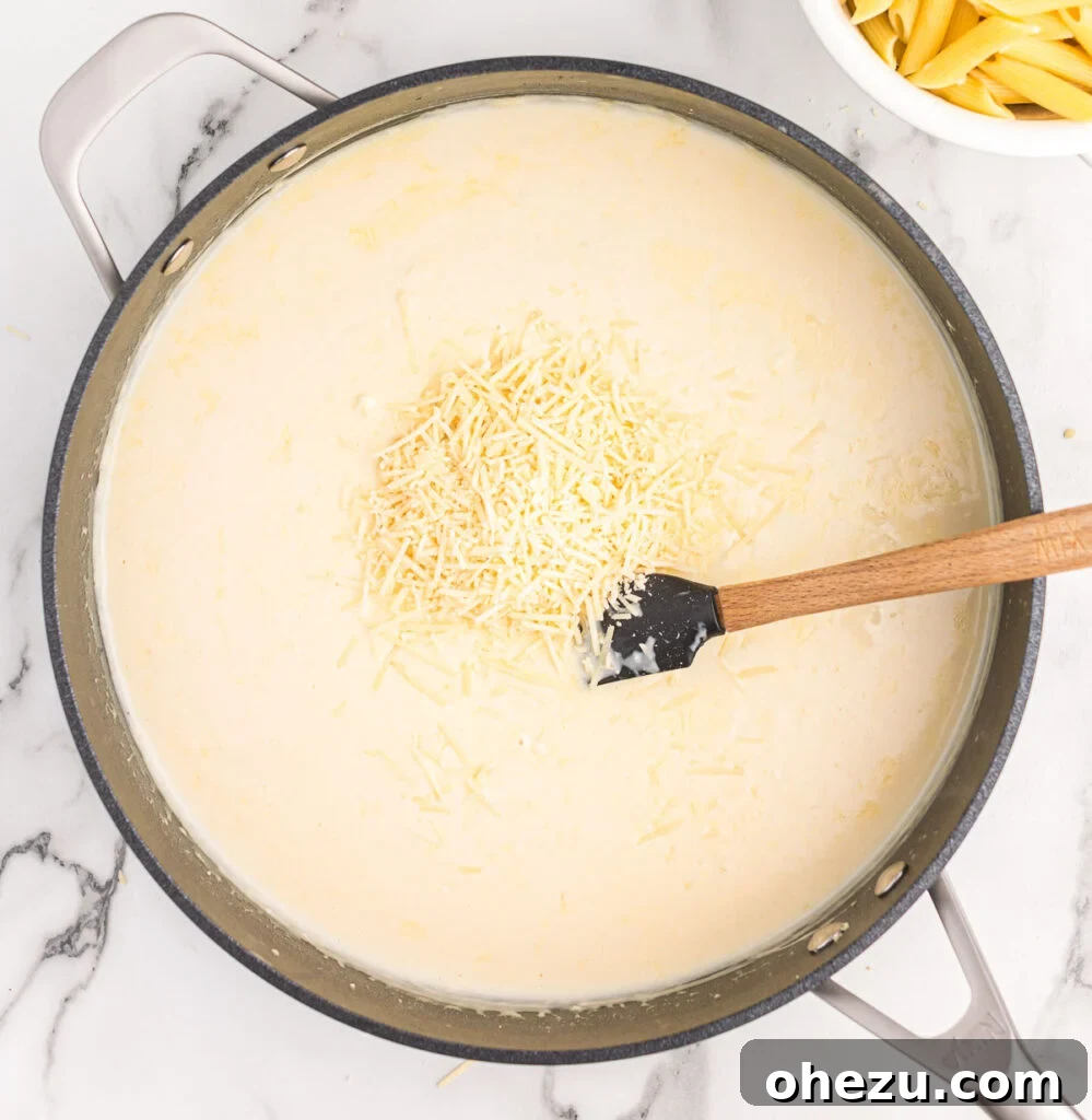 adding parmesan cheese to the cream sauce
