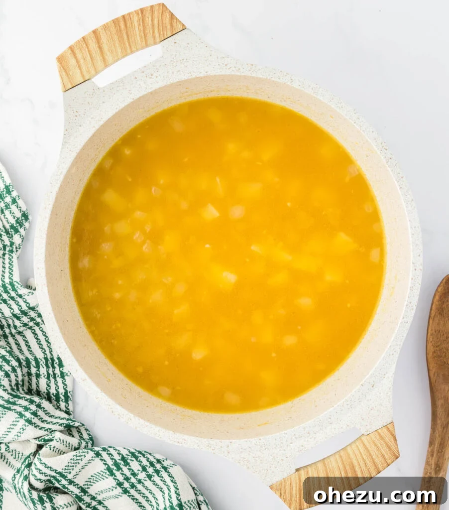Velvety Potato Warmth 11 Potatoes gently simmering in savory vegetable broth, becoming tender and releasing starch.