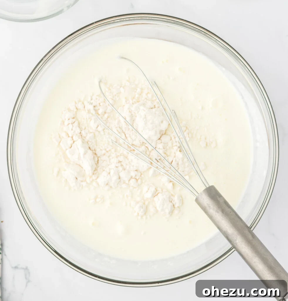 Velvety Potato Warmth 12 Whole milk, heavy cream, and flour combined in a bowl, waiting to be whisked.