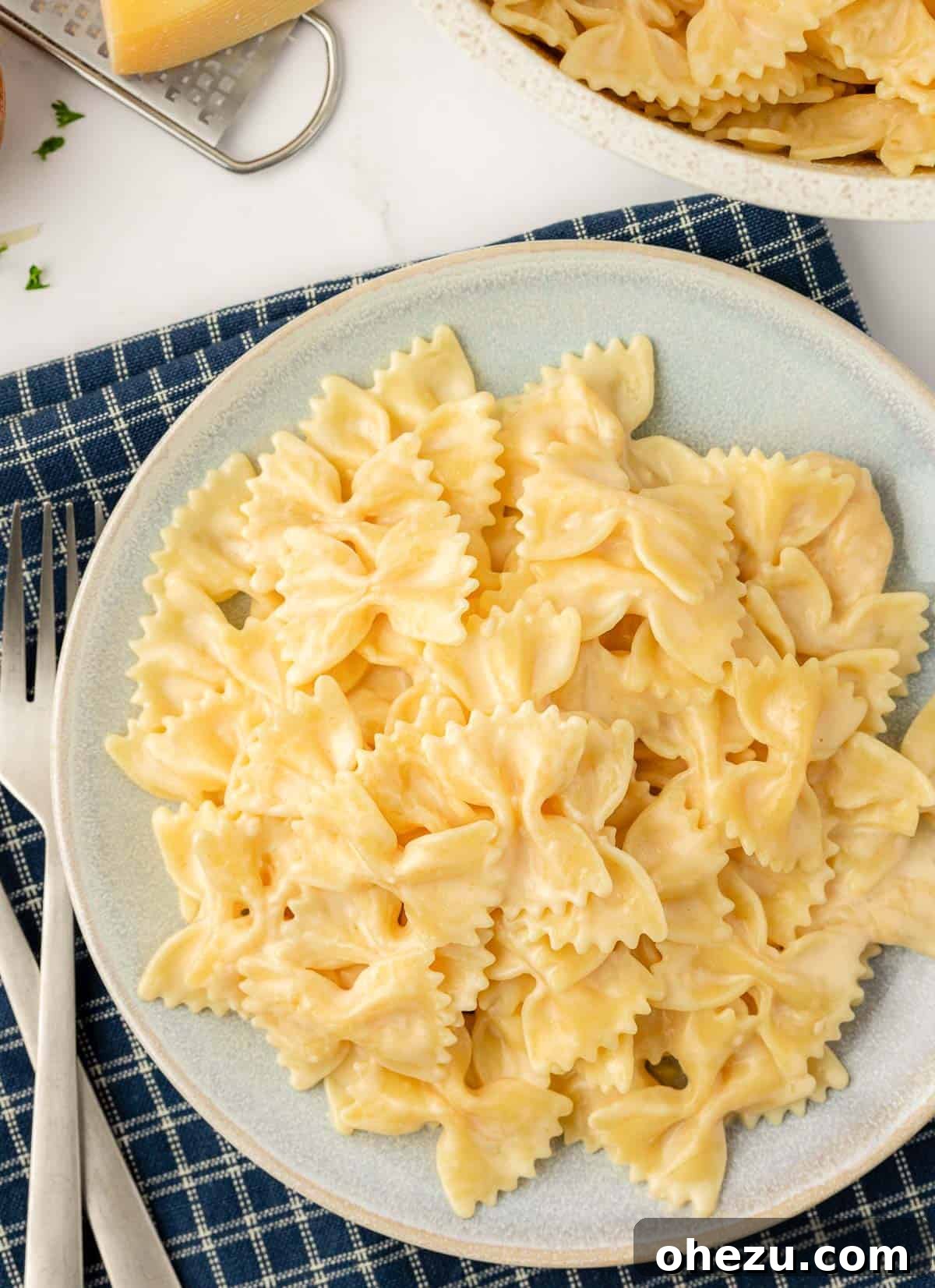 Farfalle Flair 2 A plate of creamy bow tie pasta garnished with fresh herbs, ready to be served.