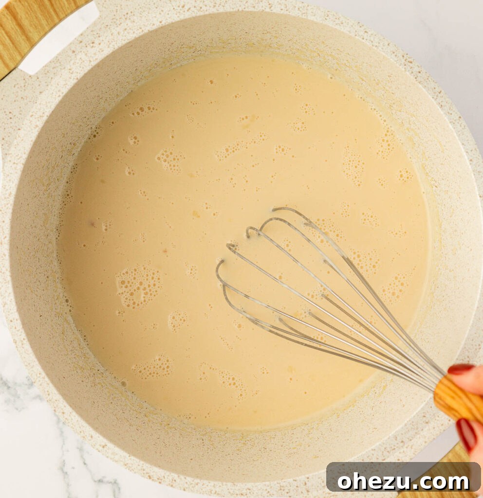 Farfalle Flair 10 Whisking the creamy sauce until it becomes smooth and thick.
